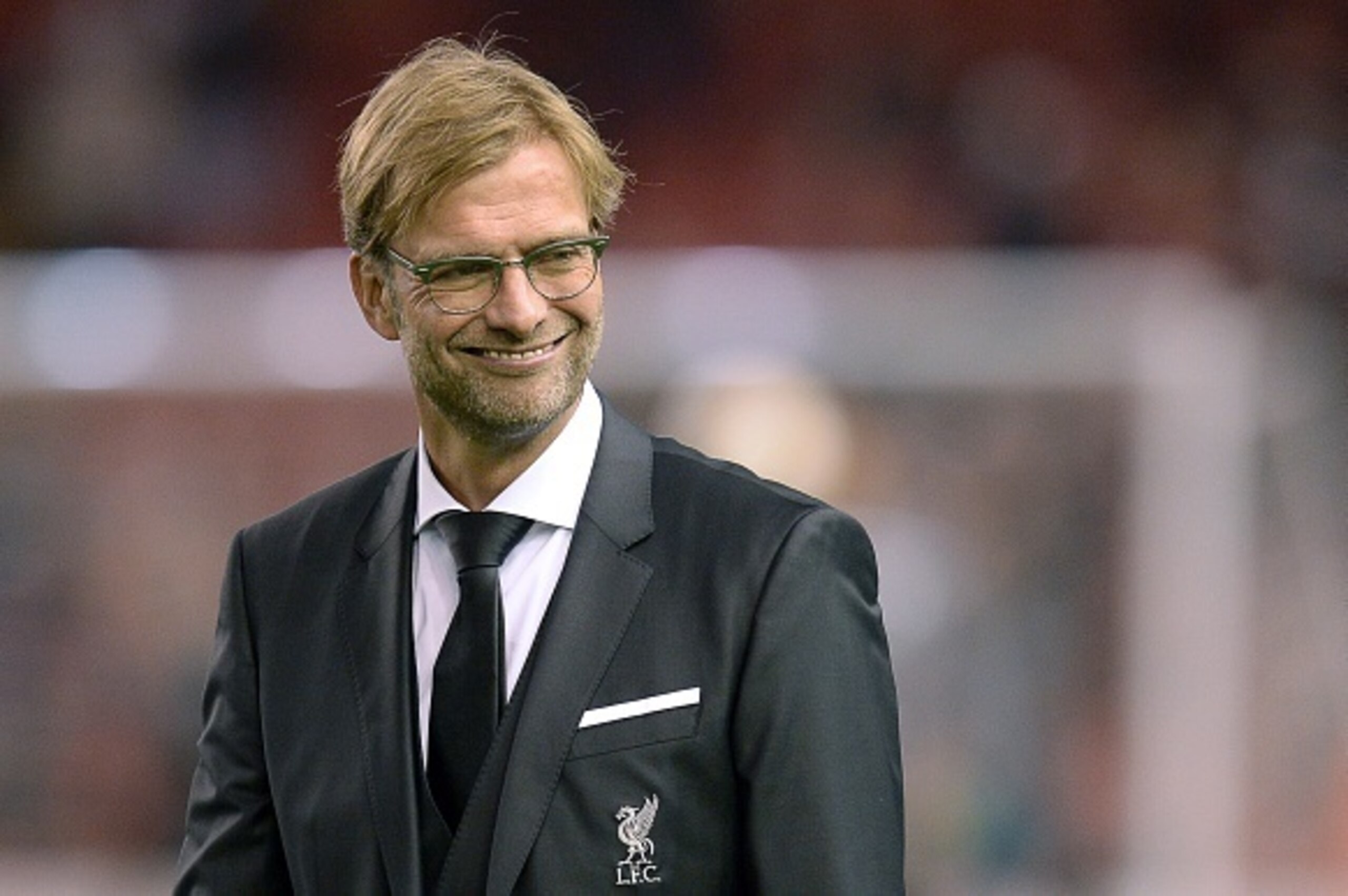 Liverpool's German manager  Jurgen Klopp smiles during warm up prior to  a UEFA Europa League group B football match between Liverpool FC and FC Rubin Kazan at Anfield in Liverpool, north west England, on October 22, 2015.  AFP PHOTO / OLI SCARFF        (