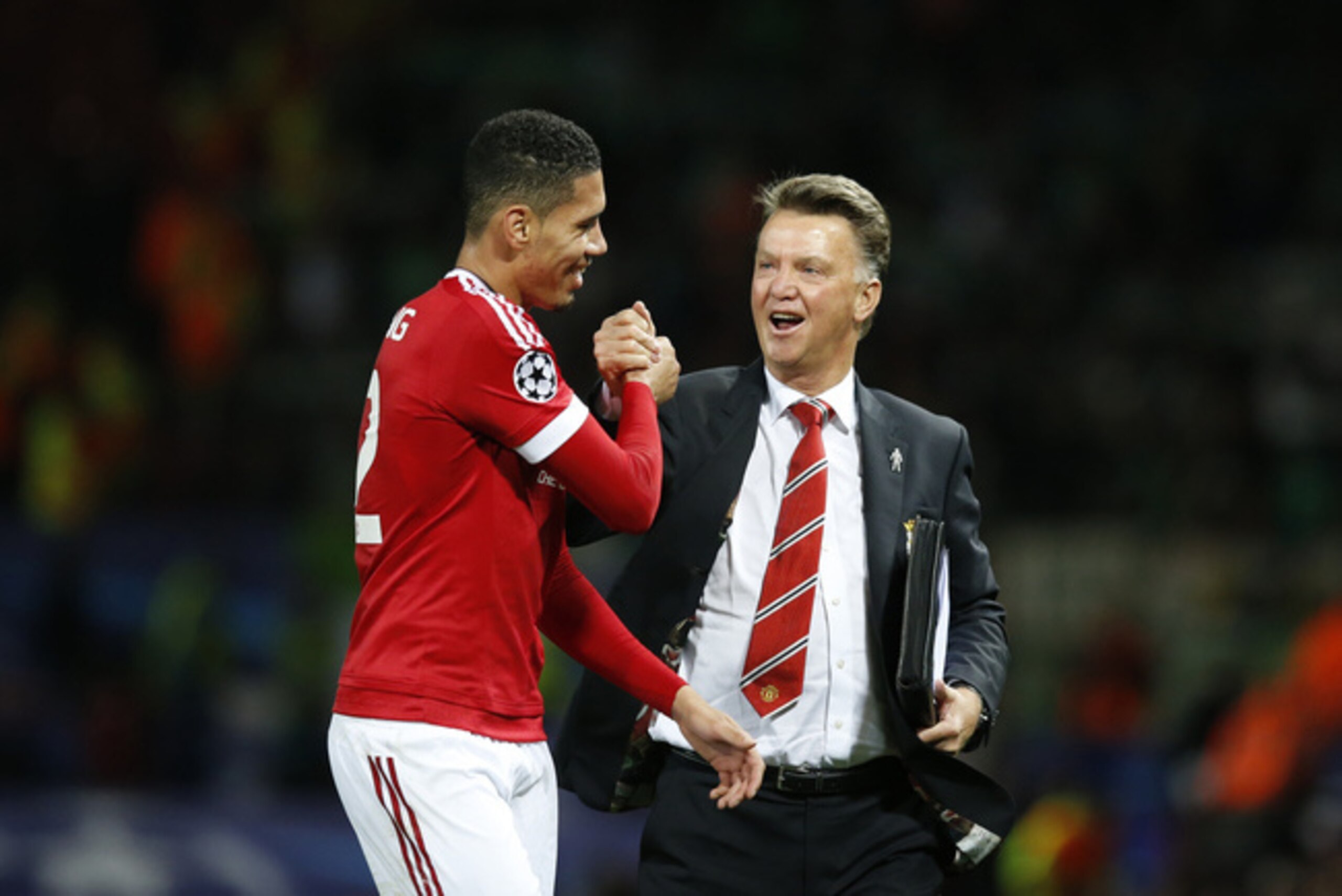 Van Gaal celebrates the Wolfsburg win with Chris Smalling.