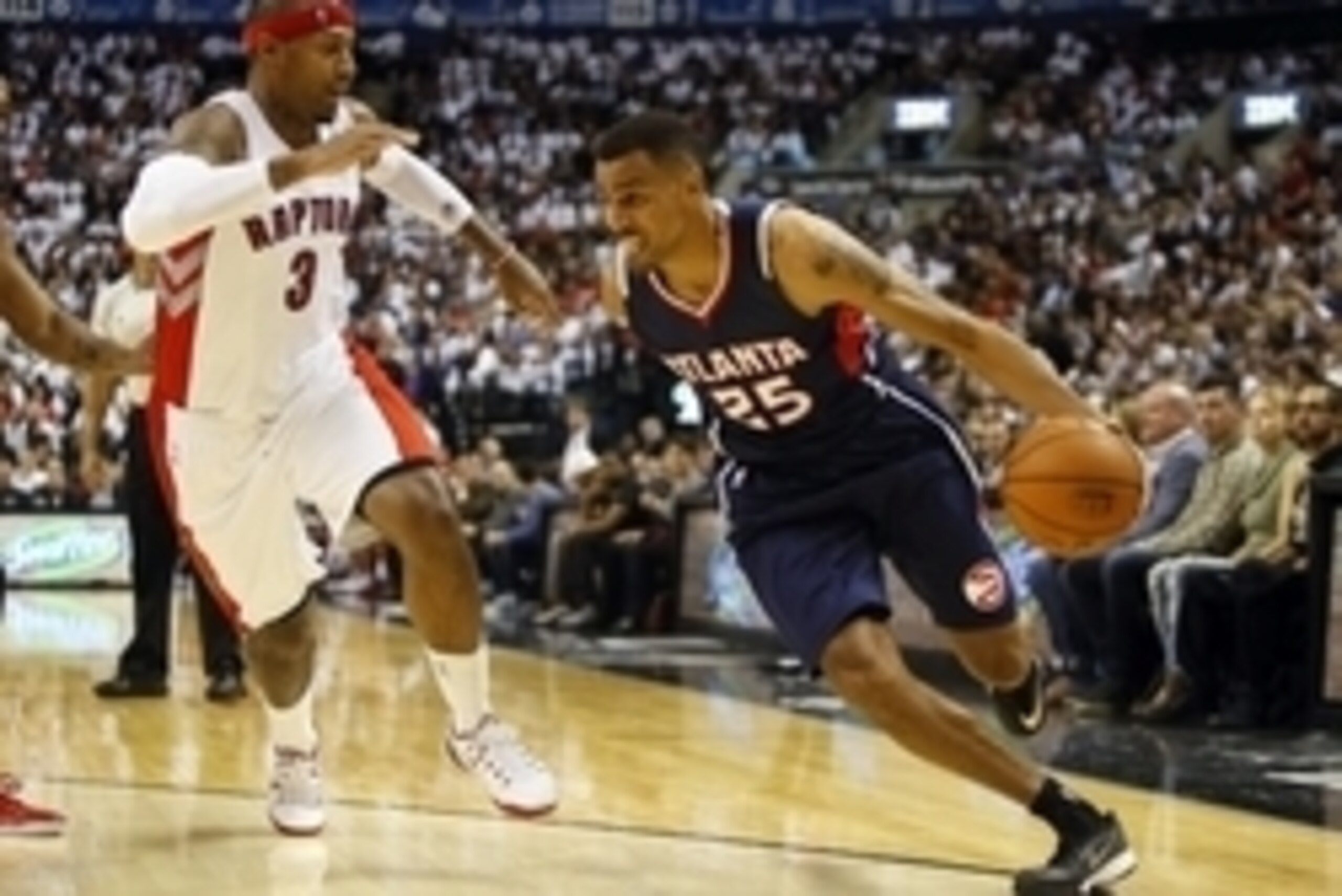 Oct 29, 2014; Toronto, Ontario, CAN; Atlanta Hawks guard Thabo Sefolosha (25) tries to get around Toronto Raptors forward James Johnson (3) at the Air Canada Centre. Toronto defeated Atlanta 109-102. Mandatory Credit: John E. Sokolowski-USA TODAY Sports