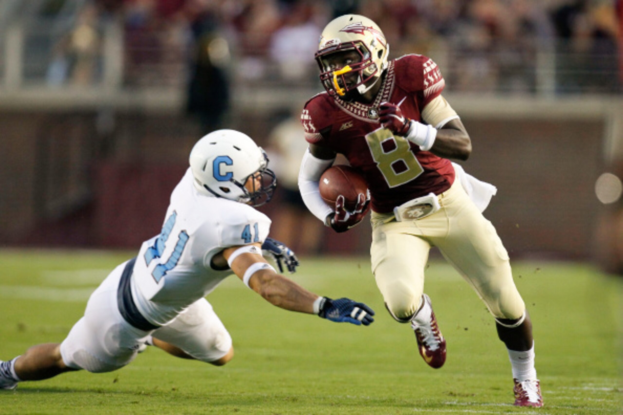 TALLAHASSEE, FL - SEPTEMBER 6: Wide Receiver Kermit Whitfield #8 of the Florida State Seminoles avoids a tackle by Cornerback Walker Smith #41 of the Citadel Bulldogs during the game at Doak Campbell Stadium on Bobby Bowden Field on September 6, 2014 in T