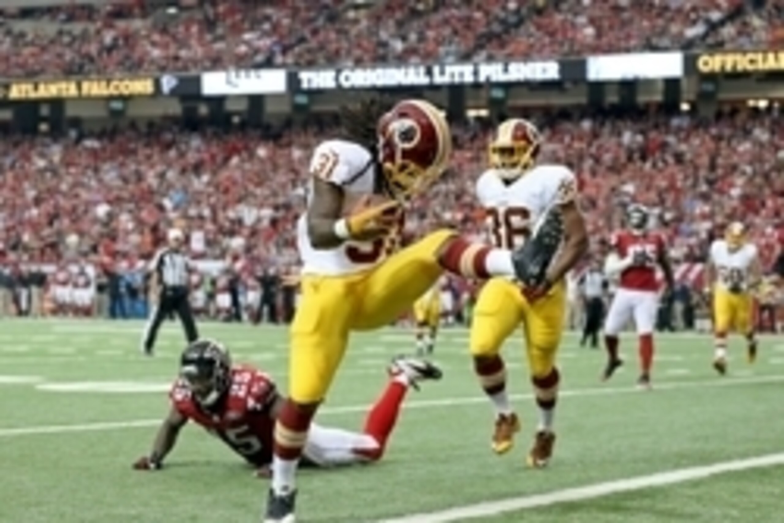 Oct 11, 2015; Atlanta, GA, USA; Washington Redskins running back Matt Jones (31) scores a rushing touchdown against Atlanta Falcons strong safety William Moore (25) in the fourth quarter of their game at the Georgia Dome. The Falcons won 25-19 in overtime