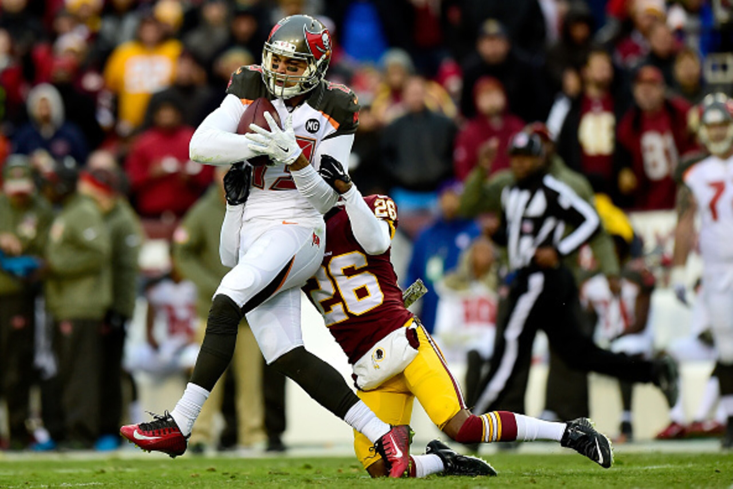 LANDOVER, MD - NOVEMBER 16: Wide receiver Mike Evans #13 of the Tampa Bay Buccaneers is tackled by cornerback Bashaud Breeland #26 of the Washington Redskins late in the third quarter at FedExField on November 16, 2014 in Landover, Maryland.  (Photo by Pa