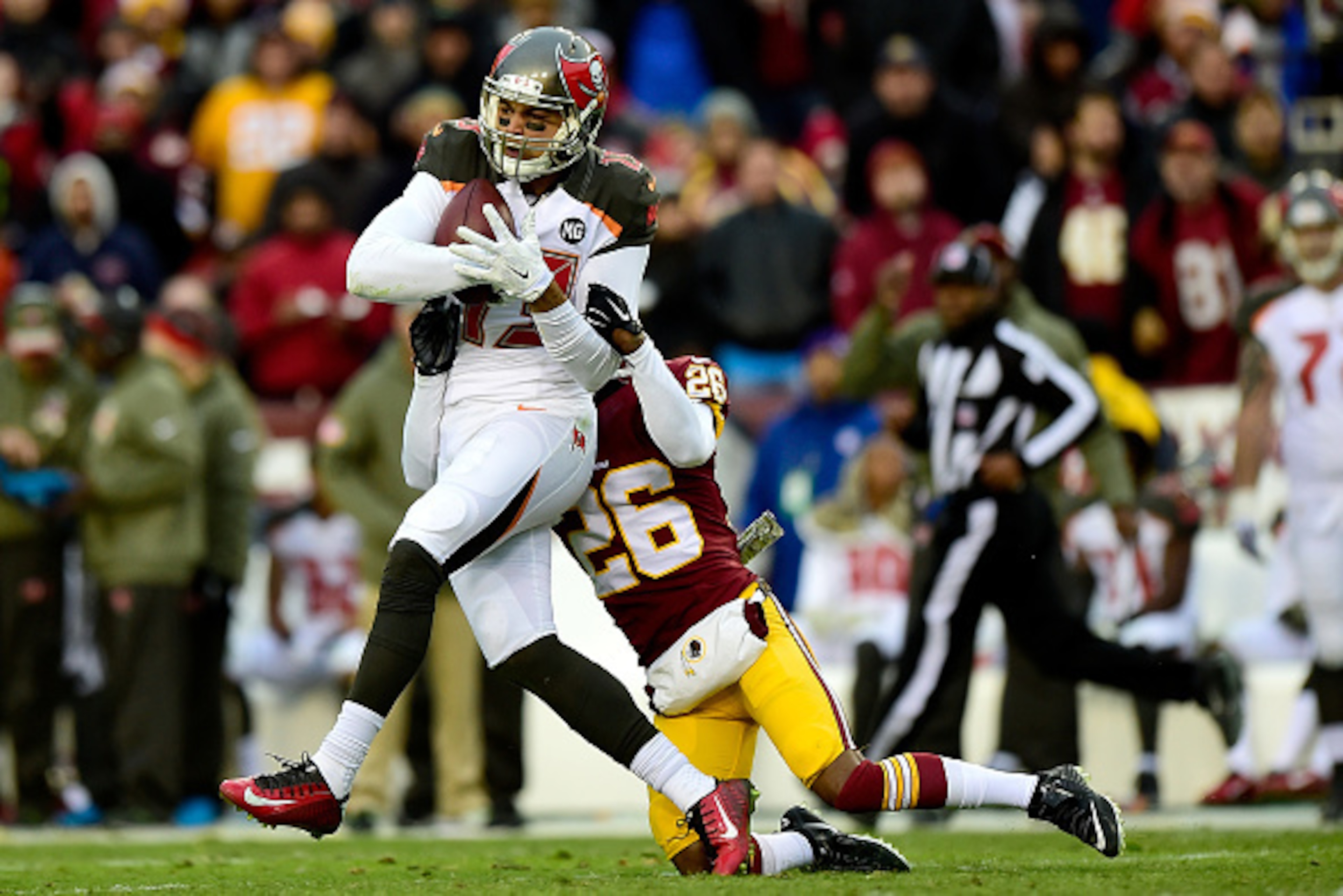 LANDOVER, MD - NOVEMBER 16: Wide receiver Mike Evans #13 of the Tampa Bay Buccaneers is tackled by cornerback Bashaud Breeland #26 of the Washington Redskins late in the third quarter at FedExField on November 16, 2014 in Landover, Maryland.  (Photo by Pa