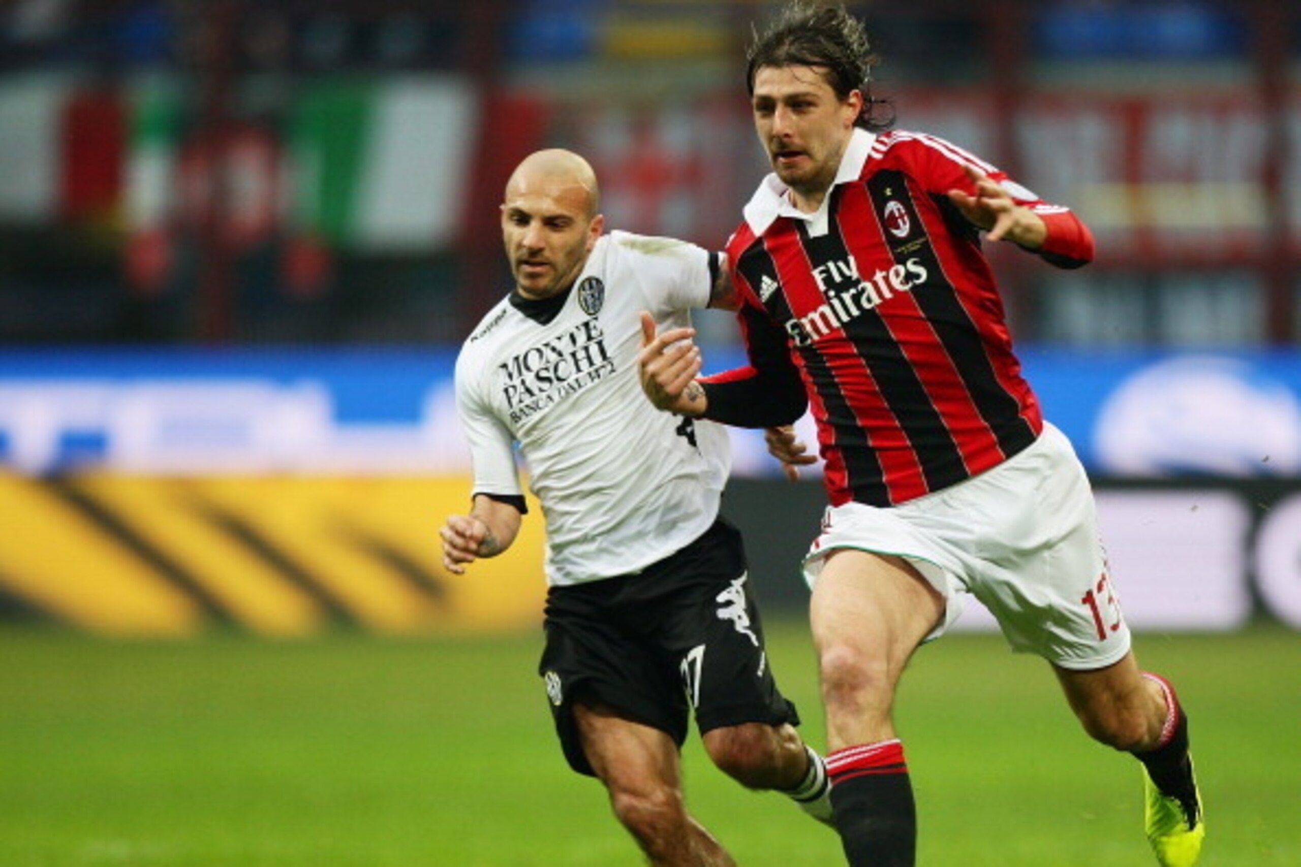 MILAN, ITALY - JANUARY 06:  Alessandro Rosina (L) of AC Siena competes for the ball with Francesco Acerbi of AC Milan during the Serie A match between AC Milan and AC Siena at San Siro Stadium on January 6, 2013 in Milan, Italy.  (Photo by Paolo Bruno/Get