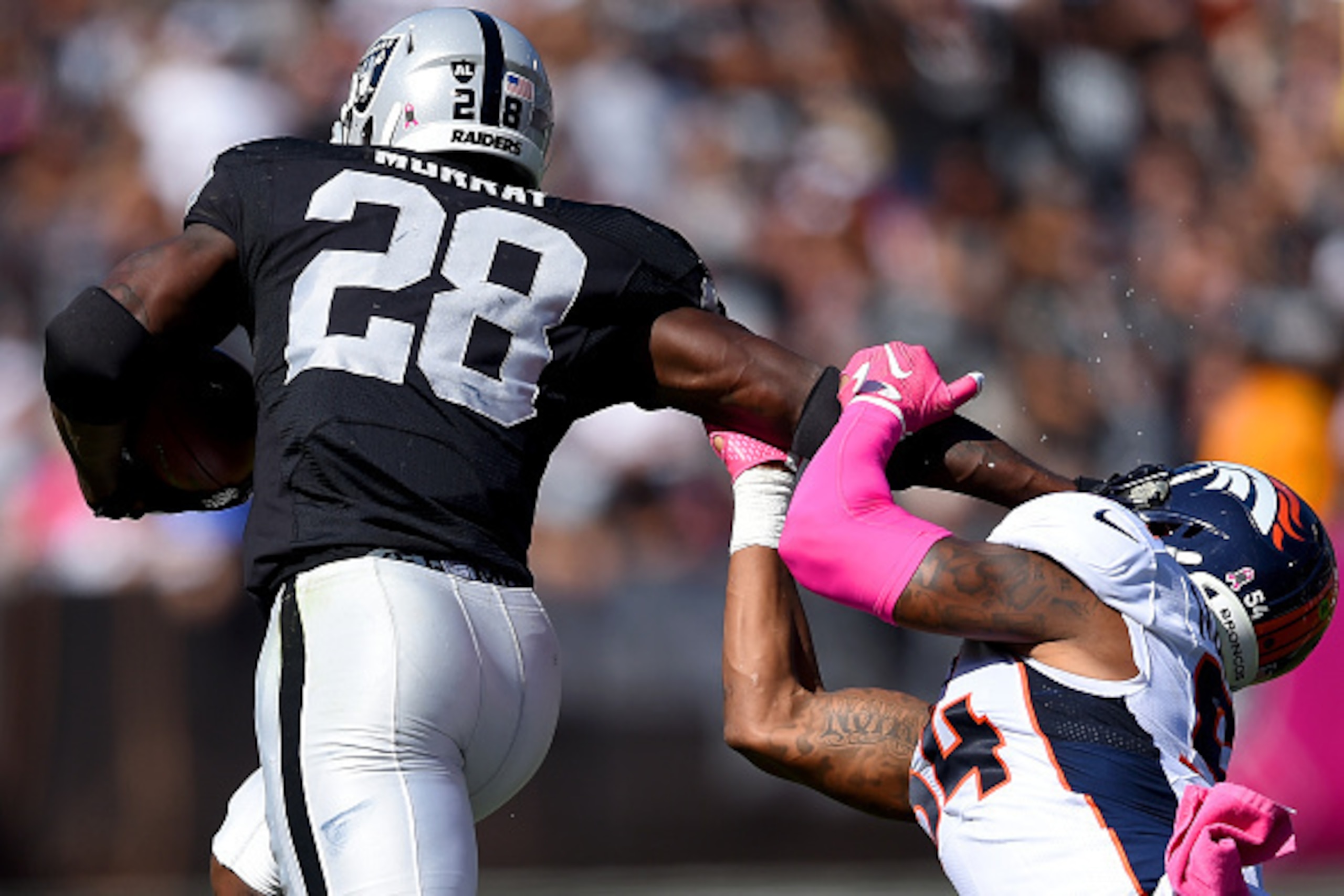 OAKLAND, CA - OCTOBER 11:  Latavius Murray #28 of the Oakland Raiders stiff arms Brandon Marshall #54 of the Denver Broncos during the second quarter at the O.co Coliseum on October 11, 2015 in Oakland, California.  (Photo by Thearon W. Henderson/Getty Im