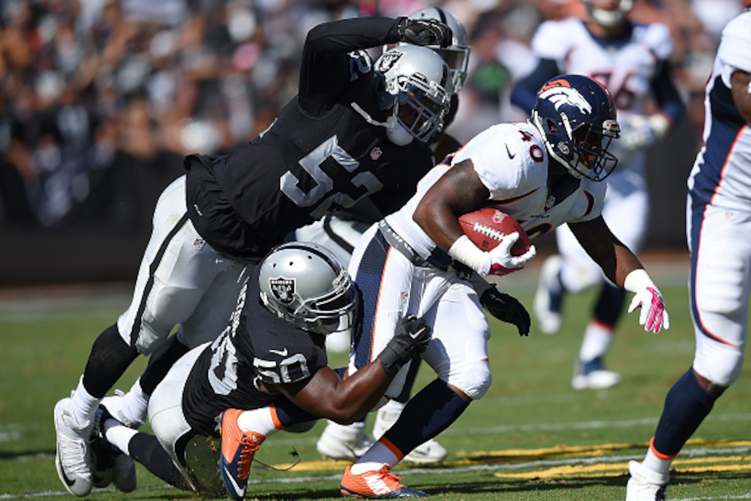 OAKLAND, CA - OCTOBER 11:  Juwan Thompson #40 of the Denver Broncos rushes with the ball while pursued by Khalil Mack #52 of the Oakland Raiders during the second quarter at the O.co Coliseum on October 11, 2015 in Oakland, California.  (Photo by Thearon 