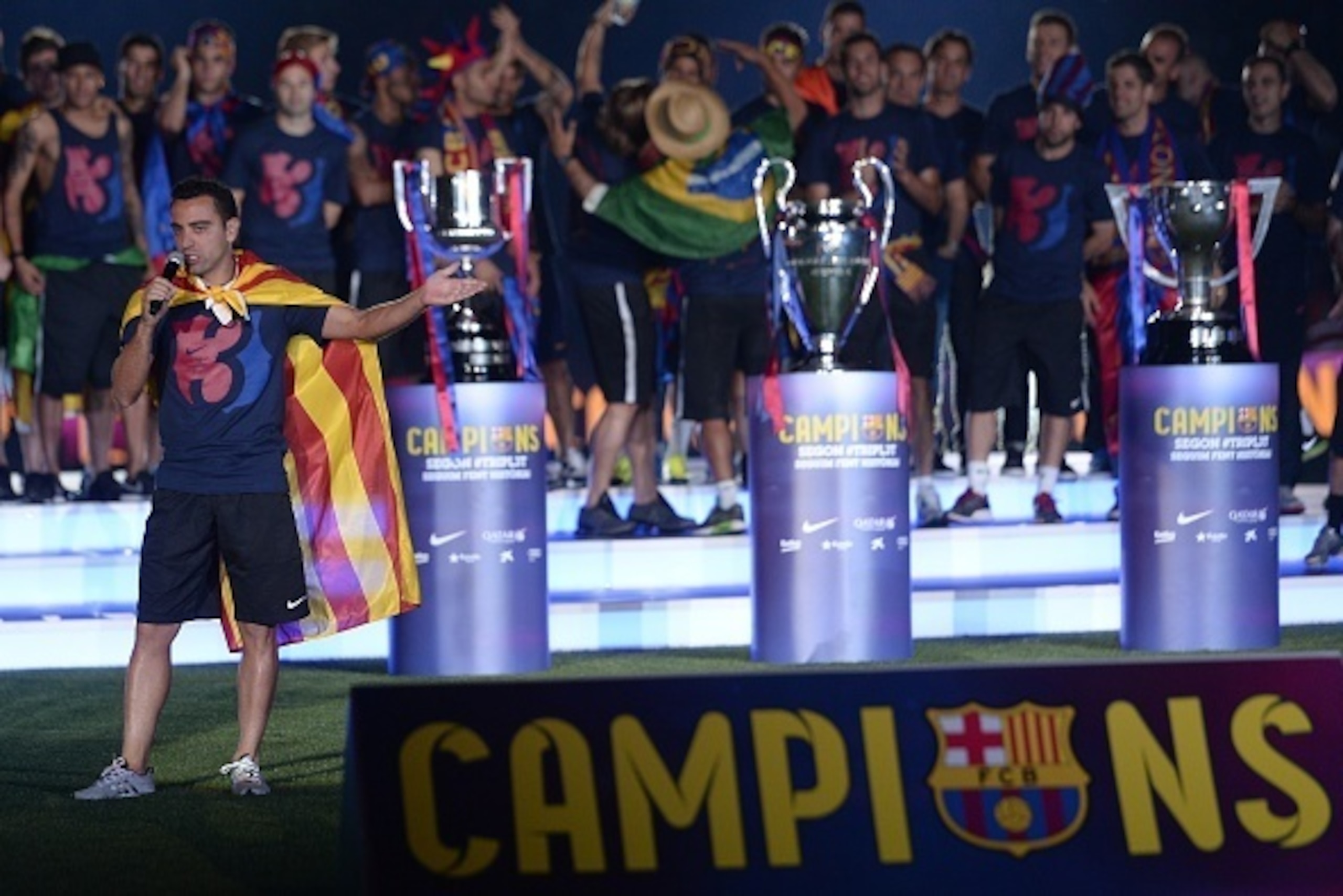 Barcelona's midfielder Xavi Hernandez delivers a speech as he takes part in the celebrations held for their victory over Juventus, one day after the UEFA Champions League final football, at the Camp Nou stadium in Barcelona on June 7, 2015. Luis Suarez an