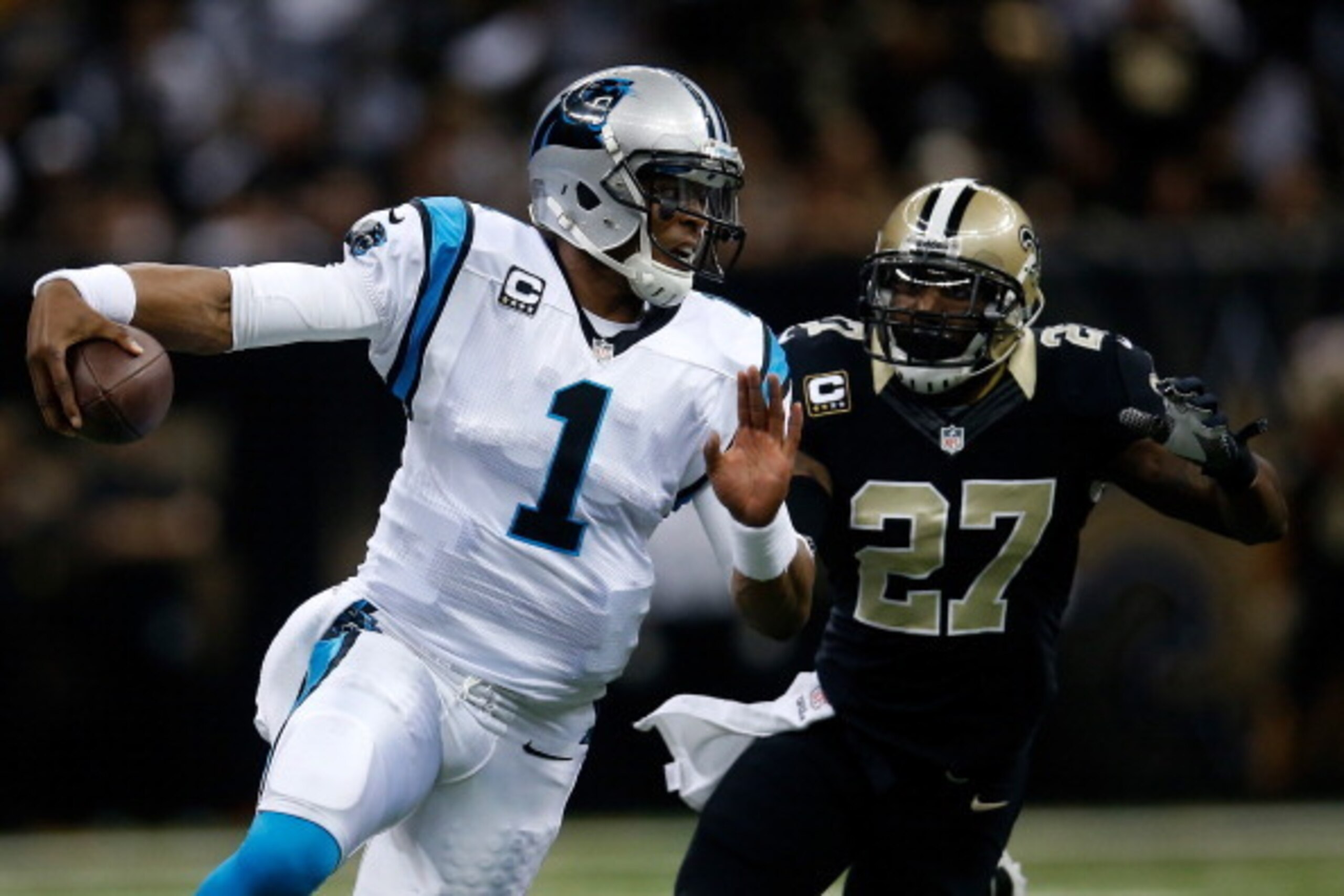 NEW ORLEANS, LA - DECEMBER 08:  Cam Newton #1 of the Carolina Panthers is tackled by  Malcolm Jenkins #27 of the New Orleans Saints at Mercedes-Benz Superdome on December 8, 2013 in New Orleans, Louisiana.  (Photo by Chris Graythen/Getty Images)