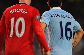 MANCHESTER, ENGLAND - APRIL 30:  Wayne Rooney of Manchester United and Sergio Aguero of Manchester City during the Barclays Premier League match between Manchester City and Manchester United at Etihad Stadium on April 30, 2012 in Manchester, England.  (Ph
