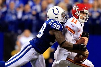 INDIANAPOLIS, IN - JANUARY 04:  Outside linebacker Robert Mathis #98 of the Indianapolis Colts forces a fumble by quarterback Alex Smith #11 of the Kansas City Chiefs during a Wild Card Playoff game at Lucas Oil Stadium on January 4, 2014 in Indianapolis,