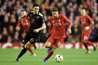 LIVERPOOL, ENGLAND - OCTOBER 22:  Adam Lallana of Liverpool is pursued by Magomed Ozdoev of Rubin Kazan during the UEFA Europa League Group B match between Liverpool FC and Rubin Kazan at Anfield on October 22, 2015 in Liverpool, United Kingdom.  (Photo b