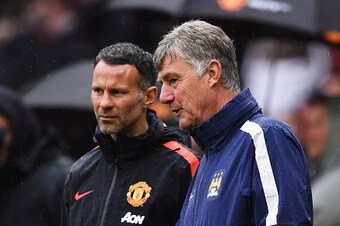 MANCHESTER, ENGLAND - APRIL 12:  Ryan Gigg assistant  manager of Manchester United and co-assistant Manager of Manchester City Brian Kidd in discussion prior to the Barclays Premier League match between Manchester United and Manchester City at Old Traffor