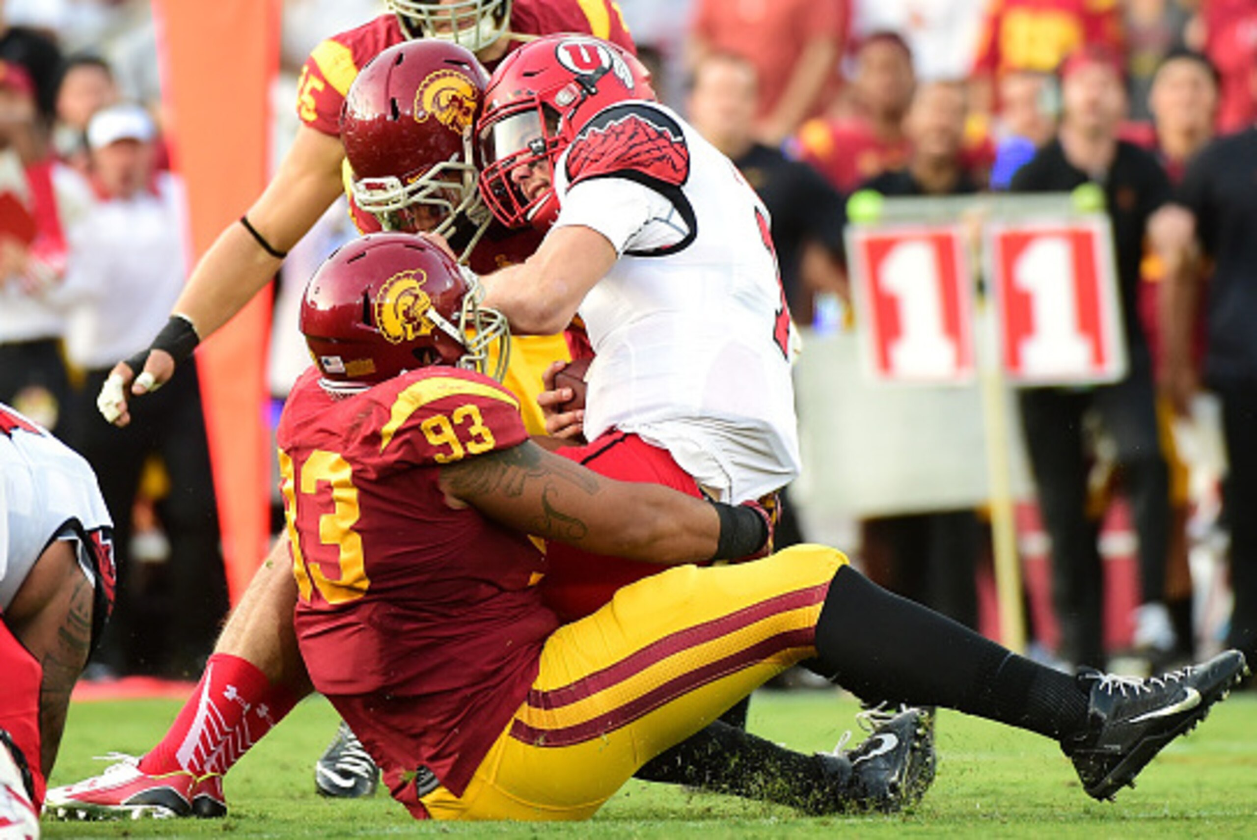 LOS ANGELES, CA - OCTOBER 24: Travis Wilson #7 of the Utah Utes is sacked by Greg Townsend Jr. #93, Osa Masina #58, and Porter Gustin #45 of the USC Trojans during the second quarter at Los Angeles Memorial Coliseum on October 24, 2015 in Los Angeles, Ca LOS ANGELES, CA - OCTOBER 24: Travis Wilson #7 of the Utah Utes is sacked by Greg Townsend Jr. #93, Osa Masina #58, and Porter Gustin #45 of the USC Trojans during the second quarter at Los Angeles Memorial Coliseum on October 24, 2015 in Los Angeles, Ca