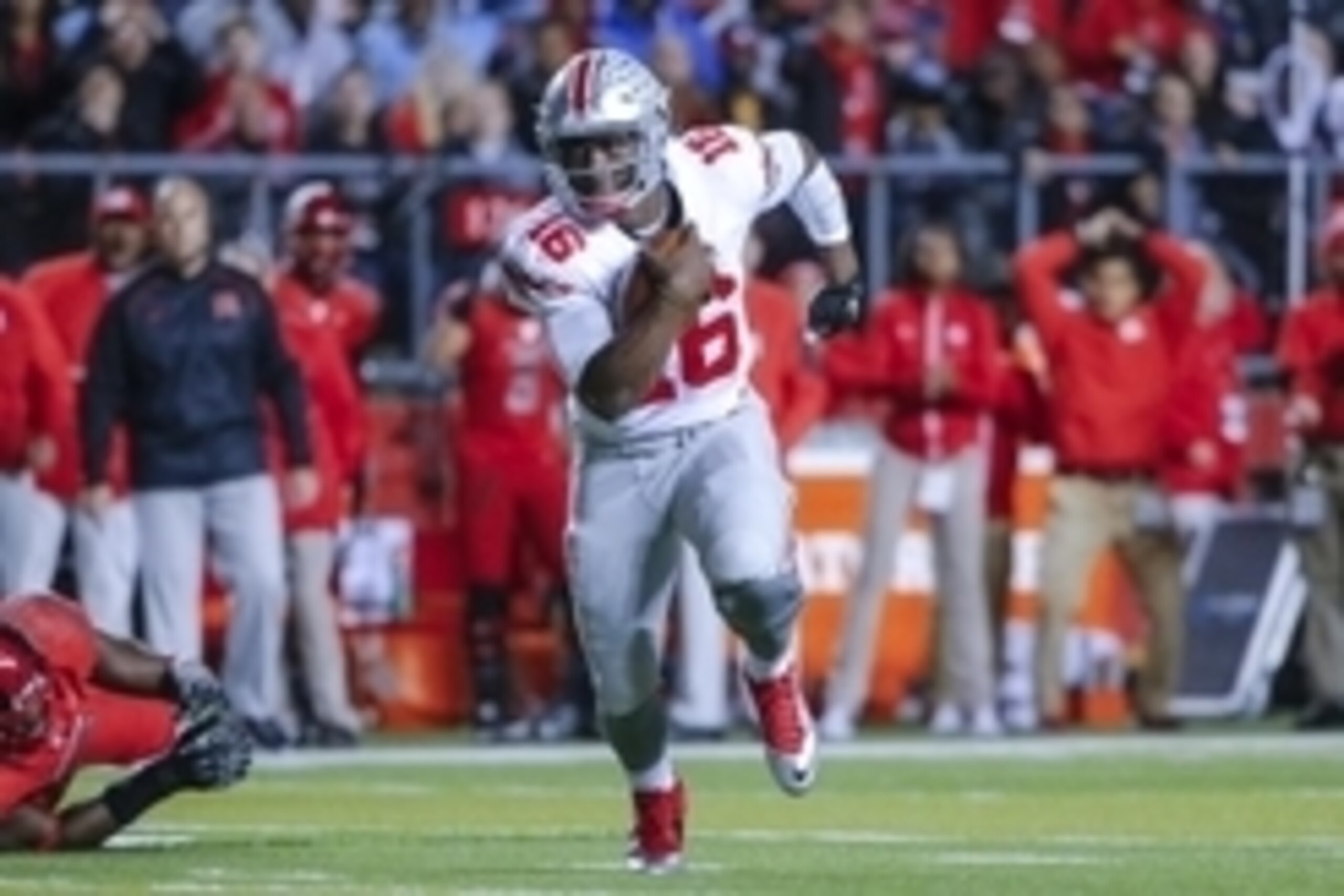Oct 24, 2015; Piscataway, NJ, USA;  Ohio State Buckeyes quarterback J.T. Barrett (16) turns up field during the first quarter against the Rutgers Scarlet Knights at High Points Solutions Stadium. Mandatory Credit: Jim O'Connor-USA TODAY Sports