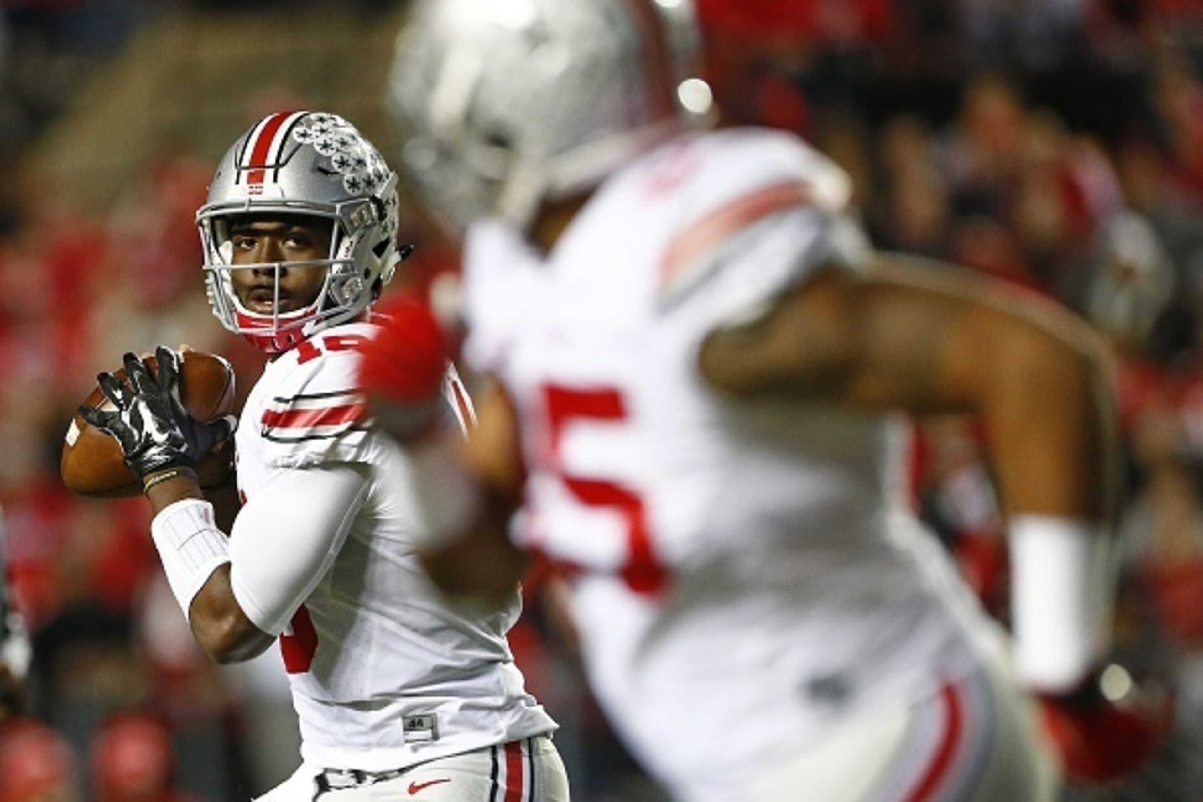 PISCATAWAY, NJ - OCTOBER 24: Quarterback J.T. Barrett #16 of the Ohio State Buckeyes looks to pass to Marcus Baugh #85 during the second quarter against the Rutgers Scarlet Knights at High Point Solutions Stadium on October 24, 2015 in Piscataway, New Jer