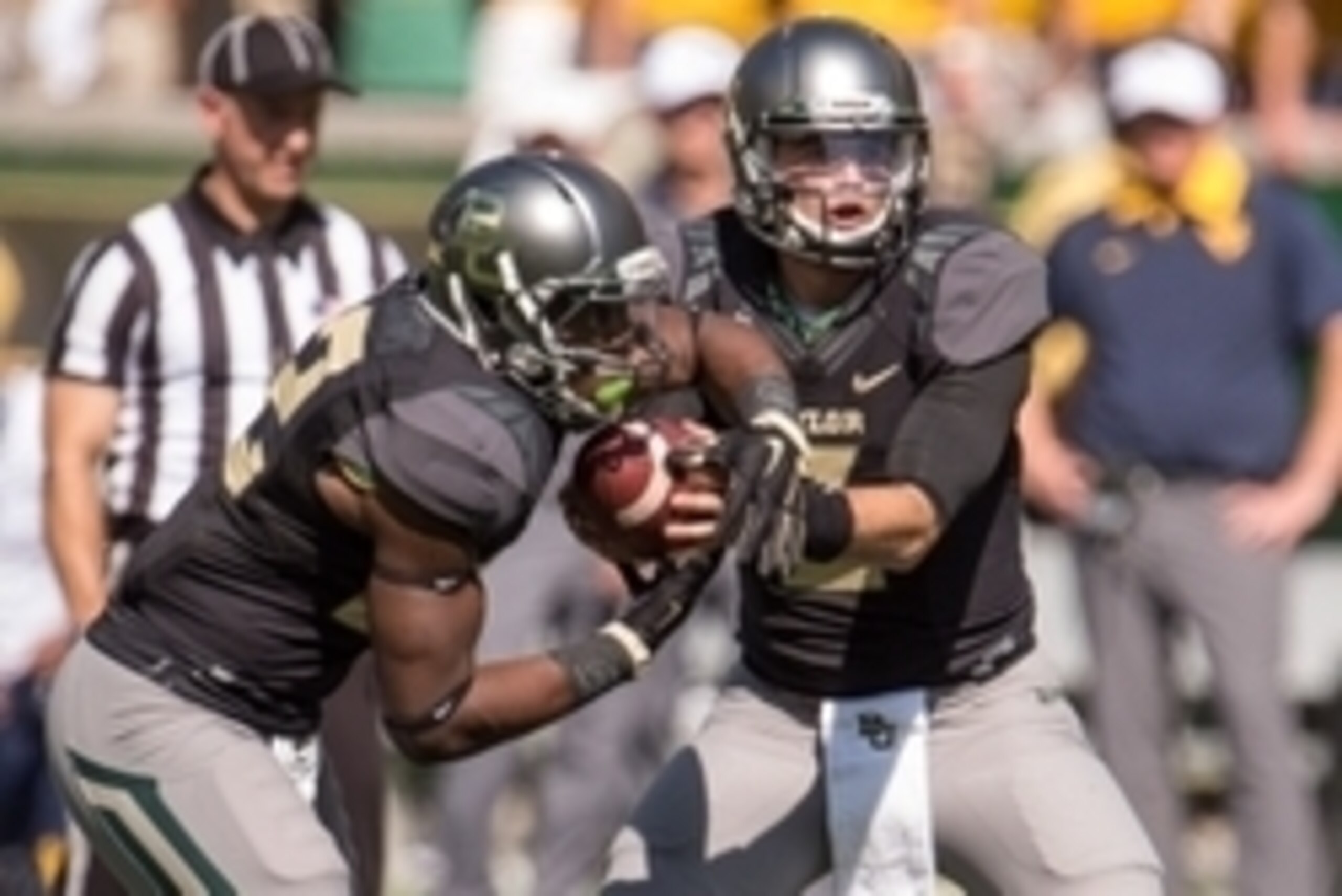 Oct 17, 2015; Waco, TX, USA; Baylor Bears quarterback Jarrett Stidham (3) hands off to running back Terence Williams (22) during the game against the West Virginia Mountaineers at McLane Stadium. The Bears defeat the Mountaineers 62-38. Mandatory Credit: Oct 17, 2015; Waco, TX, USA; Baylor Bears quarterback Jarrett Stidham (3) hands off to running back Terence Williams (22) during the game against the West Virginia Mountaineers at McLane Stadium. The Bears defeat the Mountaineers 62-38. Mandatory Credit:
