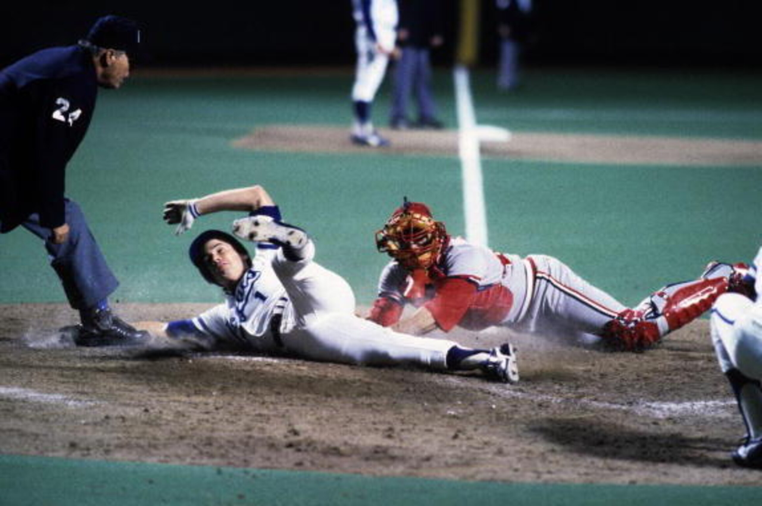 KANSAS CITY, MO - OCTOBER 20, 1985: Buddy Biancalana #1 of the Kansas City Royals tries to score as Darrell Porter #15 of the St. Louis Cardinals tags him during Game 2 of the 1985 World Series at Royals Stadium on October 20, 1985 in Kansas City, Missou KANSAS CITY, MO - OCTOBER 20, 1985: Buddy Biancalana #1 of the Kansas City Royals tries to score as Darrell Porter #15 of the St. Louis Cardinals tags him during Game 2 of the 1985 World Series at Royals Stadium on October 20, 1985 in Kansas City, Missou