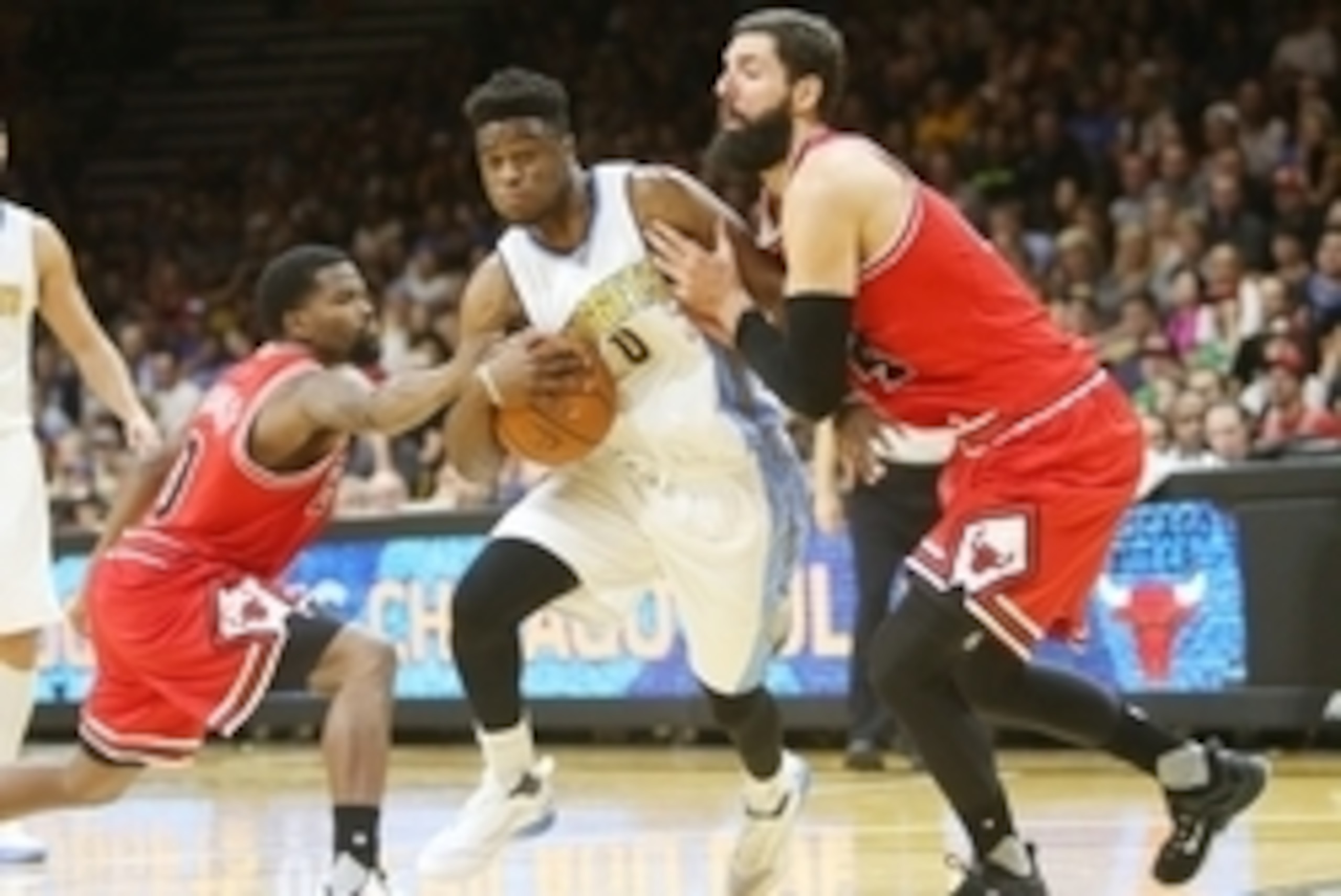 Oct 8, 2015; Boulder, CO, USA; Denver Nuggets guard Emmanuel Mudiay (C) dribbles the ball between Chicago Bulls guard Aaron Brooks (L) and forward Nikola Mirotic (R) during the first half at Coors Events Center. Mandatory Credit: Chris Humphreys-USA TODAY