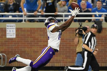 DETROIT, MI - OCTOBER 25:  Stefon Diggs #14 of the Minnesota Vikings makes a leaping touchdown catch in the third quarter of the game against the Detroit Lions at Ford Field on October 25, 2015 in Detroit, Michigan. The Vikings defeated the Lions 28-19.  