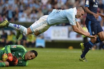 Real Madrid's Costa Rican goalkeeper Keylor Navas (L) stops a ball near Celta Vigo's forward Iago Aspas  during the Spanish league football match Celta Vigo vs Real Madrid CF at the Balaidos stadium in Vigo on October 24, 2015.  AFP PHOTO / MIGUEL RIOPA  