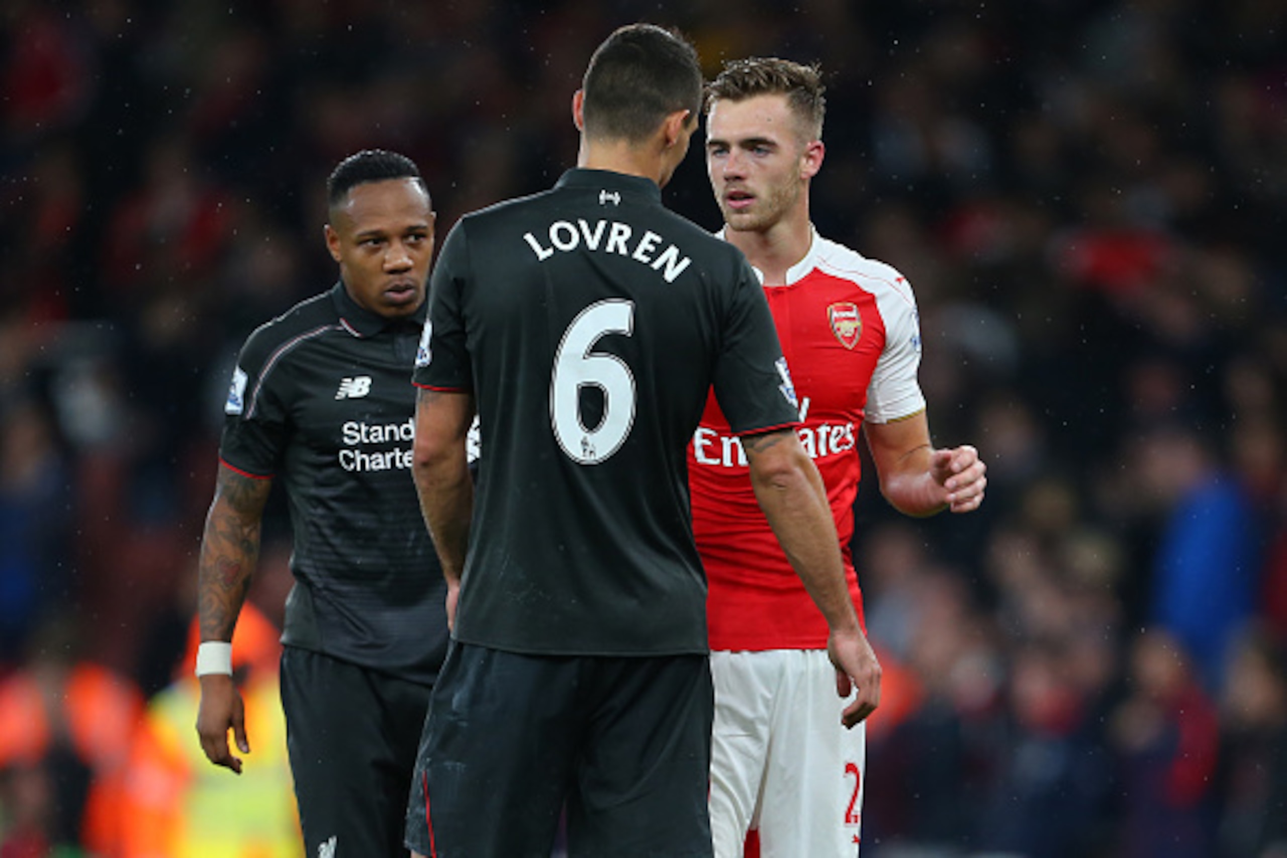 LONDON, ENGLAND - AUGUST 24:  Calum Chambers of Arsenal talks to former Southampton team mates Dejan Lovren and Nathaniel Clyne of Liverpool after the Barclays Premier League match between Arsenal and Liverpool at the Emirates Stadium on August 24, 2015 i