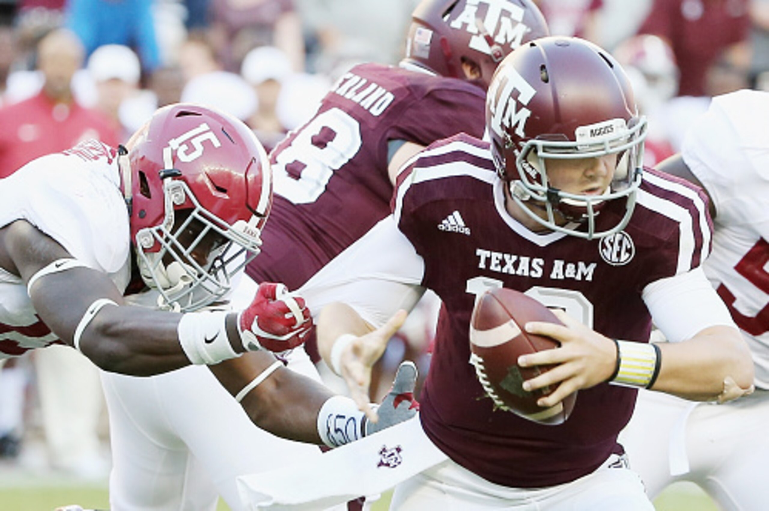 COLLEGE STATION, TX - OCTOBER 17:  Ronnie Harrison #15 of the Alabama Crimson Tide tackles Kyle Allen #10 of the Texas A&M Aggies in the second half of their game at Kyle Field on October 17, 2015 in College Station, Texas.  (Photo by Scott Halleran/Getty