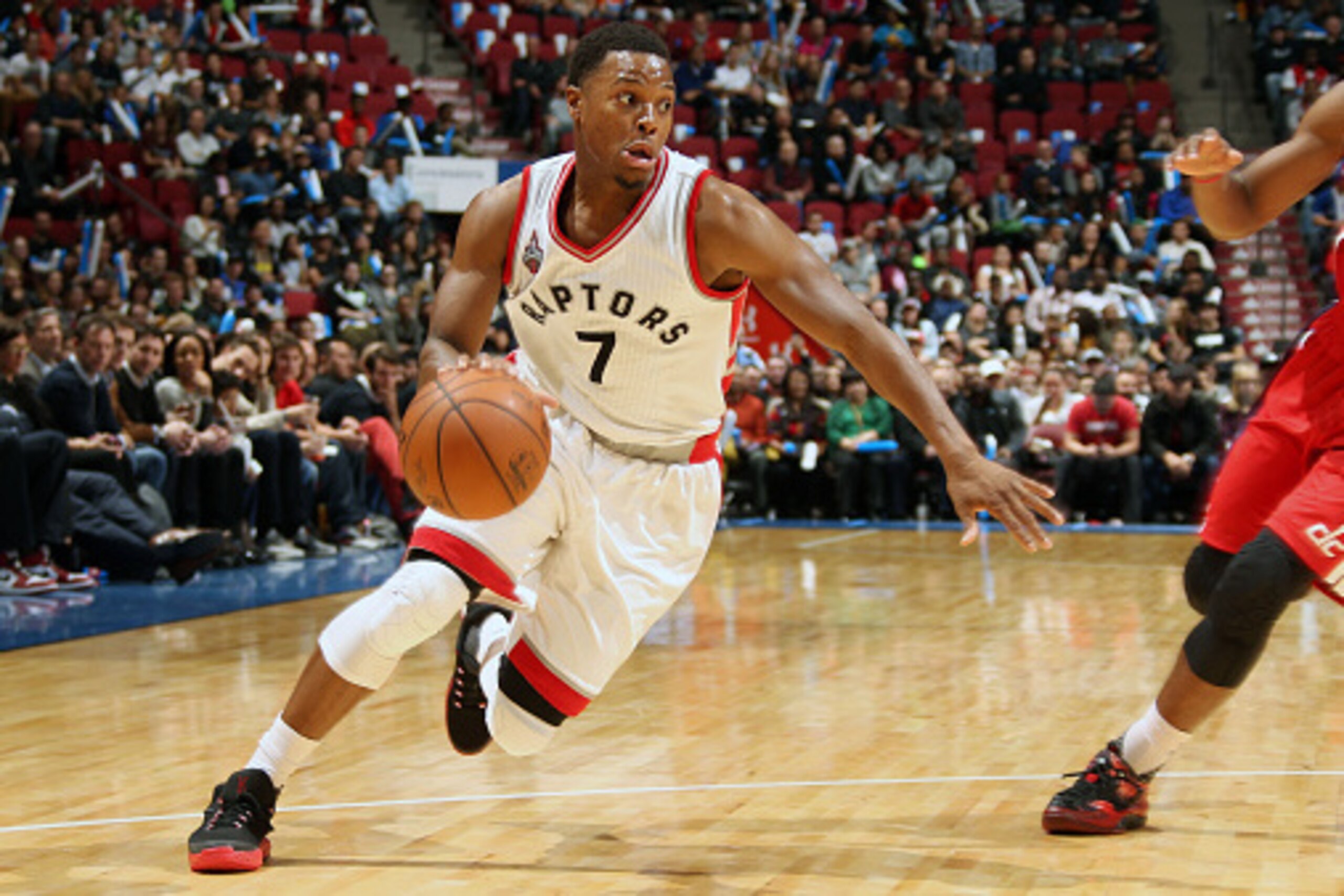 MONTREAL, QC - OCTOBER 23:  Kyle Lowry #7 of the Toronto Raptors handles the ball against Ramon Sessions #7 of the Washington Wizards at the Centre Bell on October 23, 2015 in Montreal, Quebec, Canada. NOTE TO USER: User expressly acknowledges and agrees 