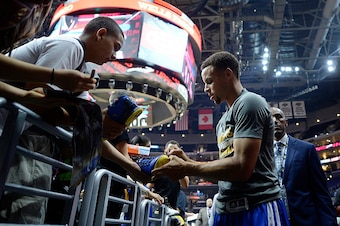 LOS ANGELES CA - OCTOBER 20: Stephen Curry #30 of the Golden State Warriors signs an autograph before the start of the pre-season basketball gamer against the Los Angeles Clippers at Staples Center October 20, 2015 in Los Angeles, California. NOTE TO USER