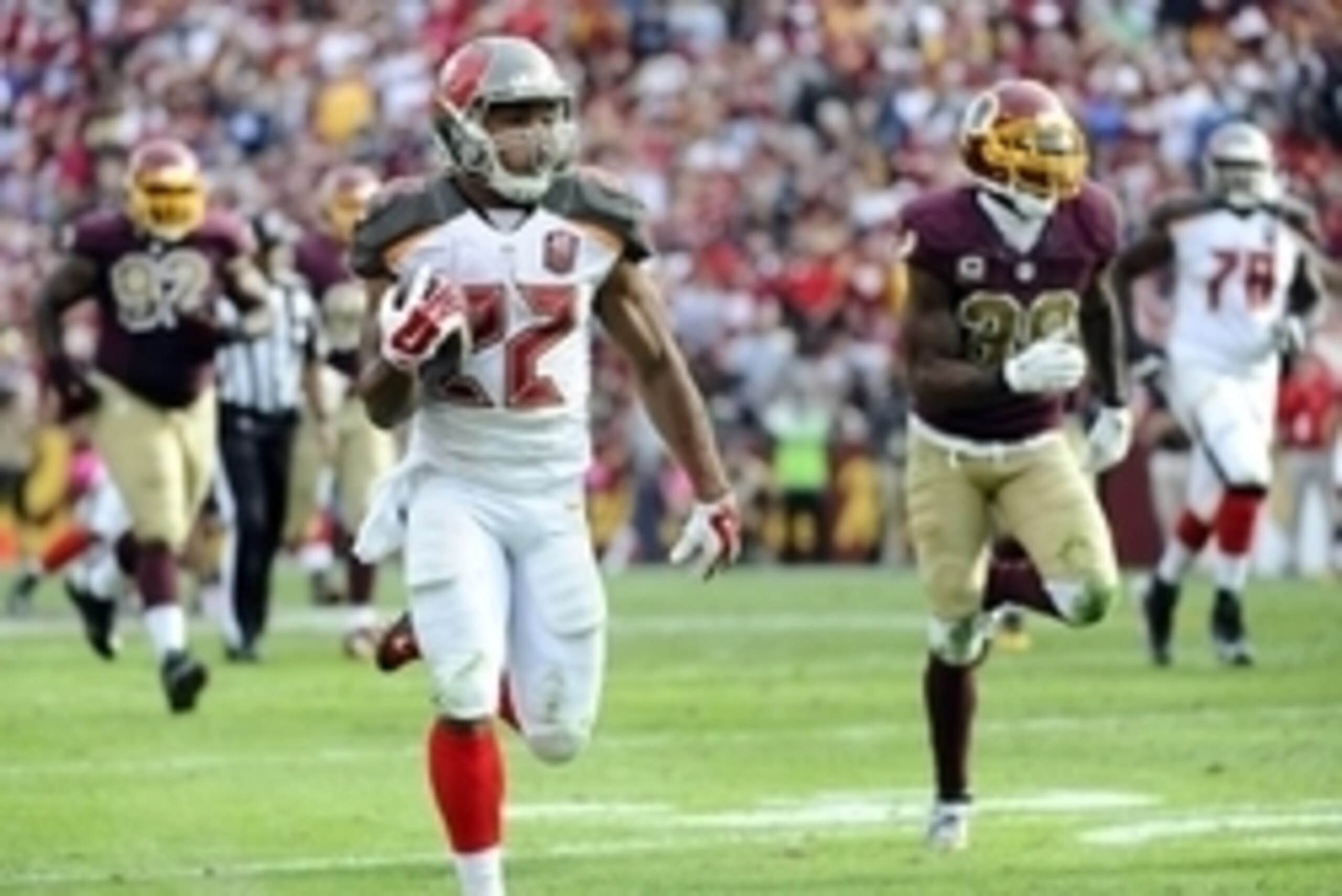 Oct 25, 2015; Landover, MD, USA; Tampa Bay Buccaneers running back Doug Martin (22) carries the ball as Washington Redskins free safety Dashon Goldson (38) and defensive end Chris Baker (92) chase during the second half at FedEx Field. The Washington Reds
