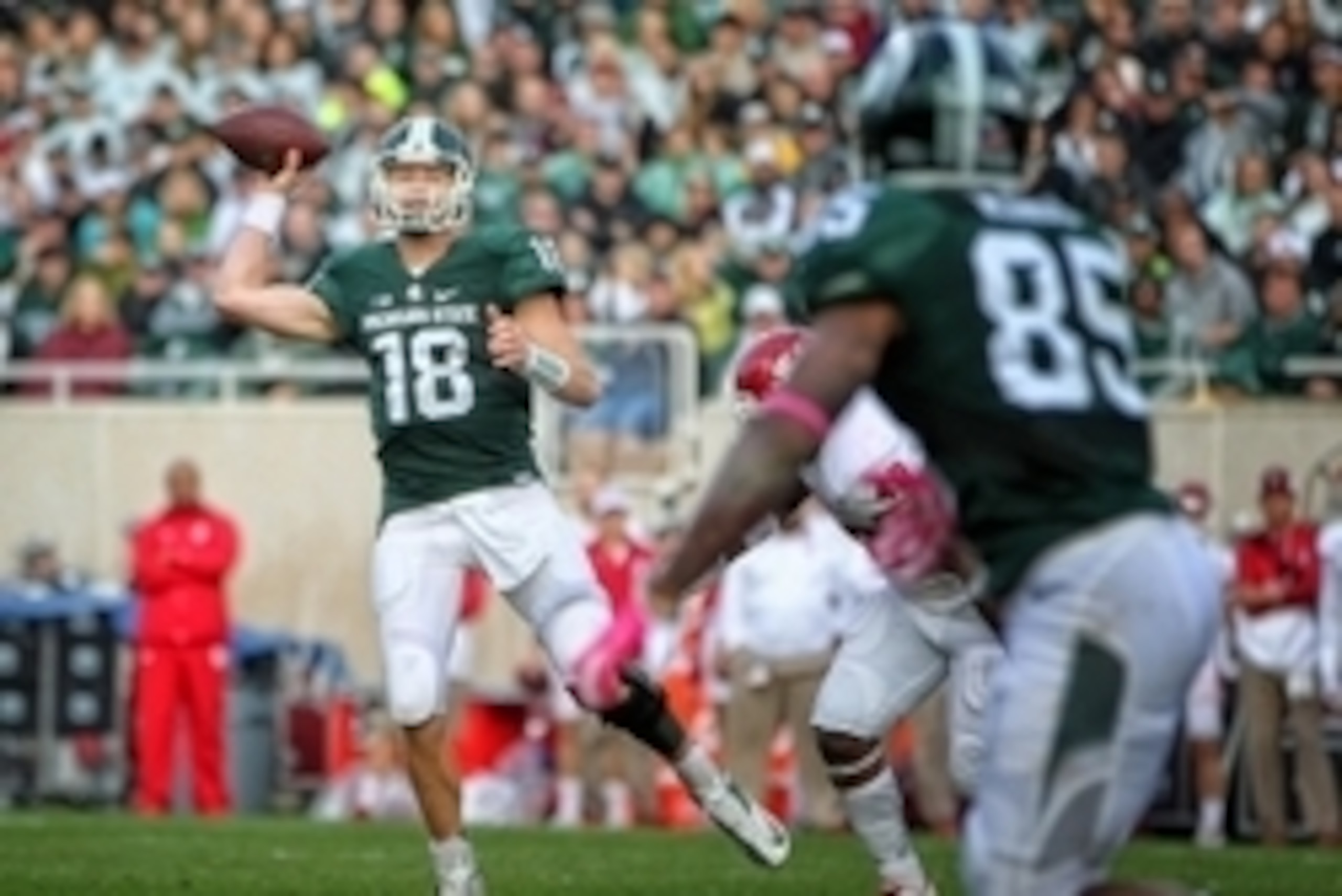 Oct 24, 2015; East Lansing, MI, USA; Michigan State Spartans quarterback Connor Cook (18) throws off his back foot against the Indiana Hoosiers during the 1st half of a game at Spartan Stadium. Mandatory Credit: Mike Carter-USA TODAY Sports