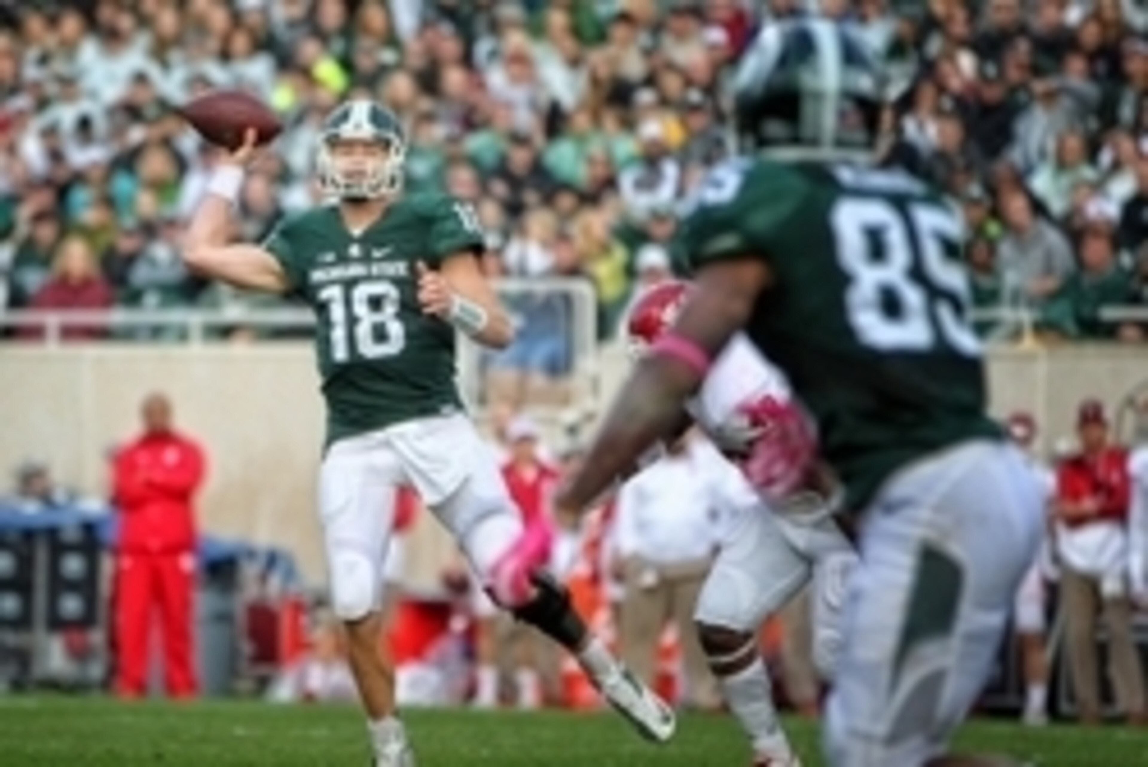 Oct 24, 2015; East Lansing, MI, USA; Michigan State Spartans quarterback Connor Cook (18) throws off his back foot against the Indiana Hoosiers during the 1st half of a game at Spartan Stadium. Mandatory Credit: Mike Carter-USA TODAY Sports