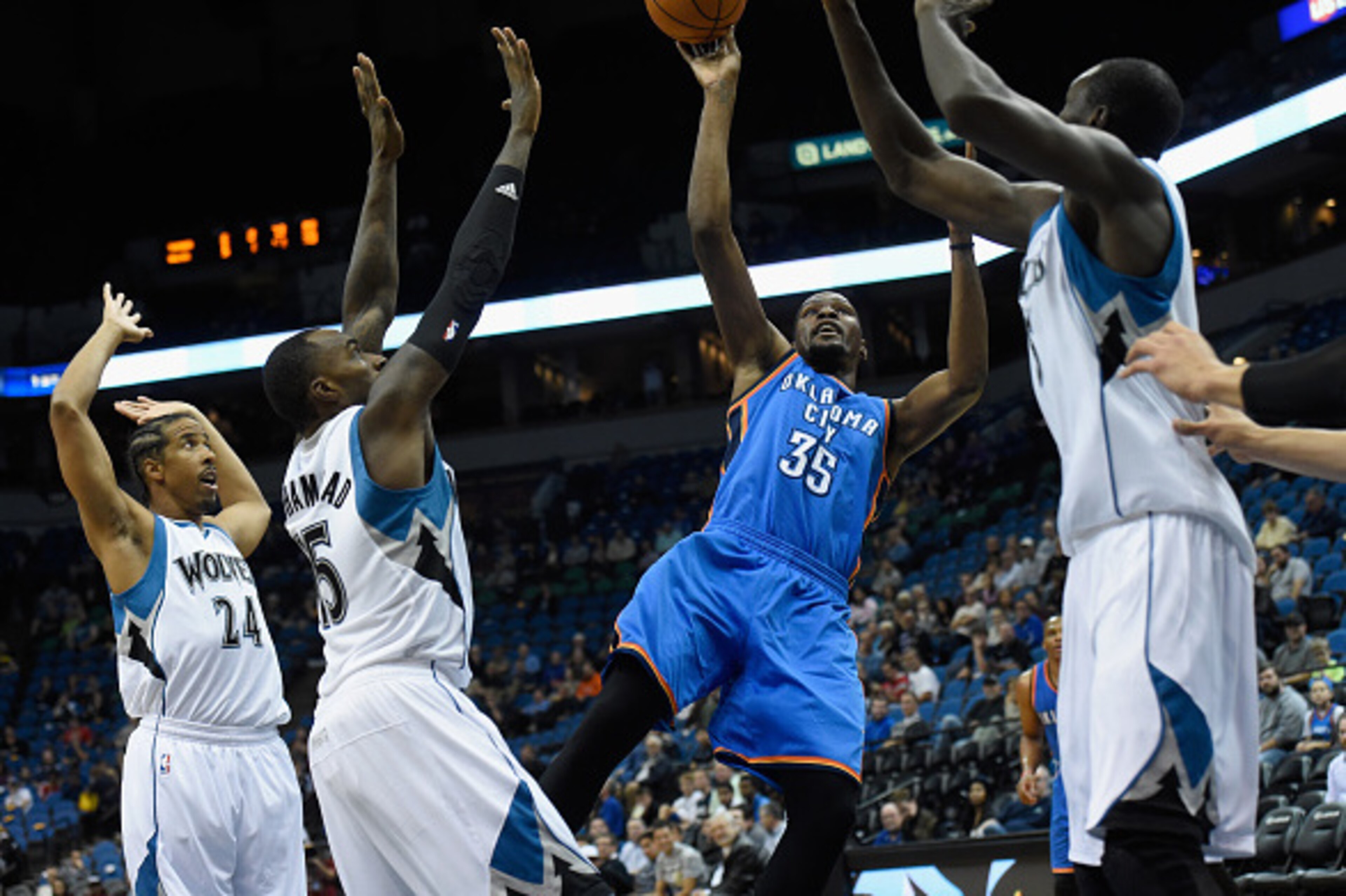 MINNEAPOLIS, MN - OCTOBER 7: Kevin Durant #35 of the Oklahoma City Thunder shoots against Andre Miller #24, Shabazz Muhammad #15 and Gorgui Dieng #5 of the Minnesota Timberwolves during the first quarter of the preseason game on October 7, 2015 at Target 