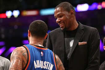 LOS ANGELES, CA - MARCH 01: Injured player Kevin Durant of the Oklahoma City Thunder talks with D.J. Augustin #14 during the game against the Los Angeles Lakers at Staples Center on March 1, 2015 in Los Angeles, California.  The Thunder won 108-101.   NOT