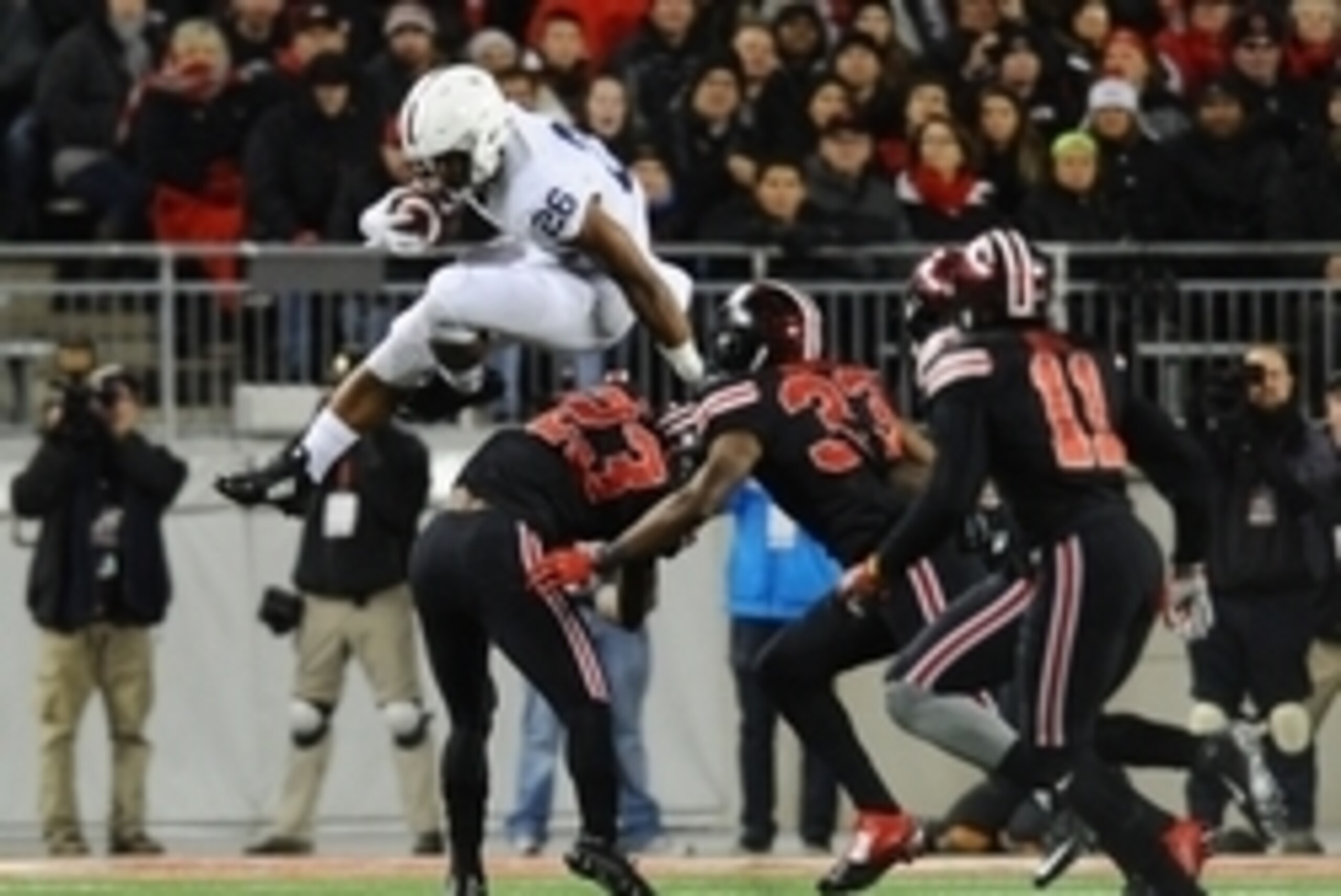 Oct 17, 2015; Columbus, OH, USA; Penn State Nittany Lions running back Saquon Barkley (26) hurdles over Ohio State Buckeyes safety Tyvis Powell (23) as linebacker Dante Booker (33) and safety Vonn Bell (11) defend in the second quarter at Ohio Stadium. Ma
