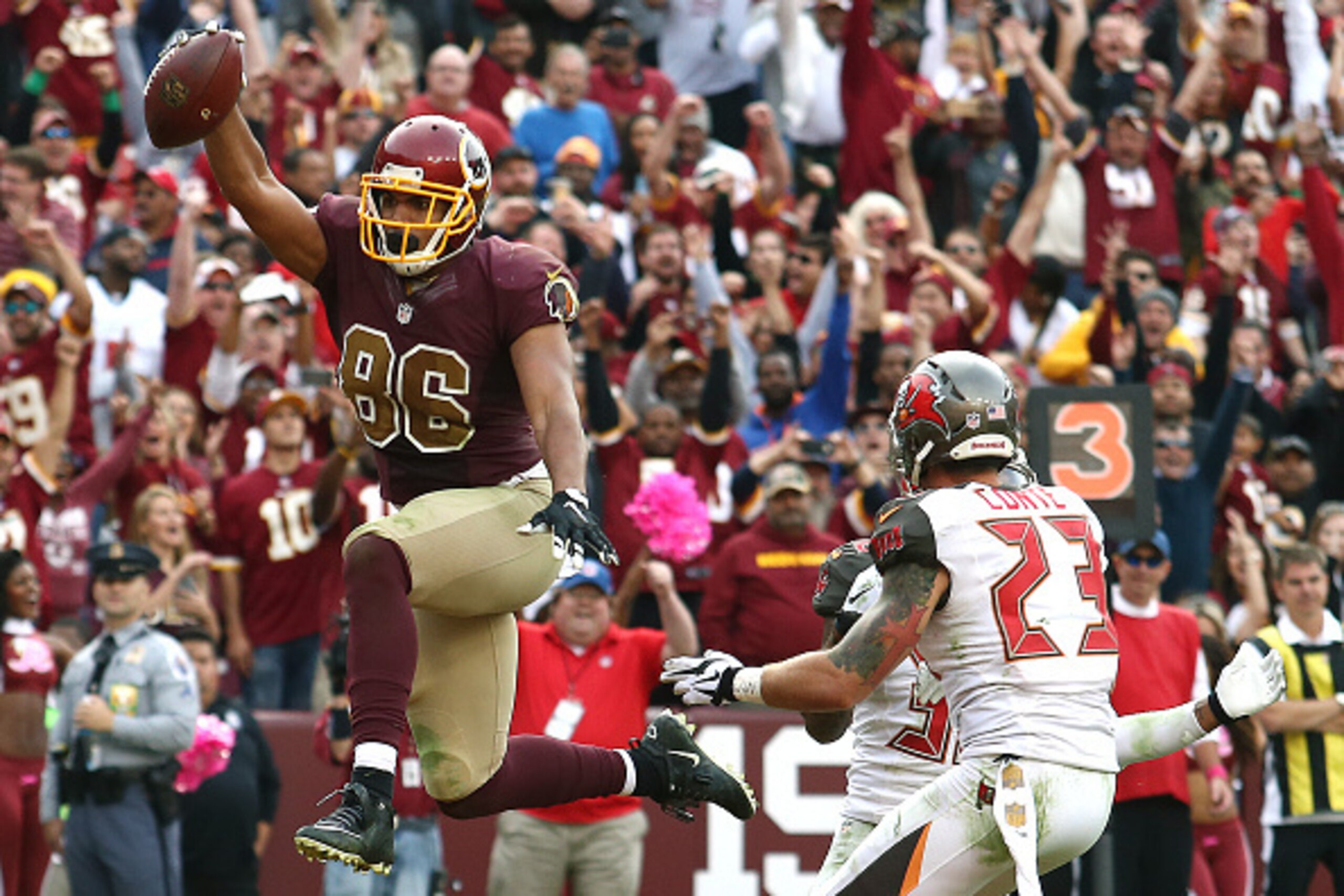 LANDOVER, MD - OCTOBER 25: Tight end Jordan Reed #86 of the Washington Redskins scores a fourth quarter touchdown past strong safety Chris Conte #23 of the Tampa Bay Buccaneers during a game at FedExField on October 25, 2015 in Landover, Maryland. (Photo 
