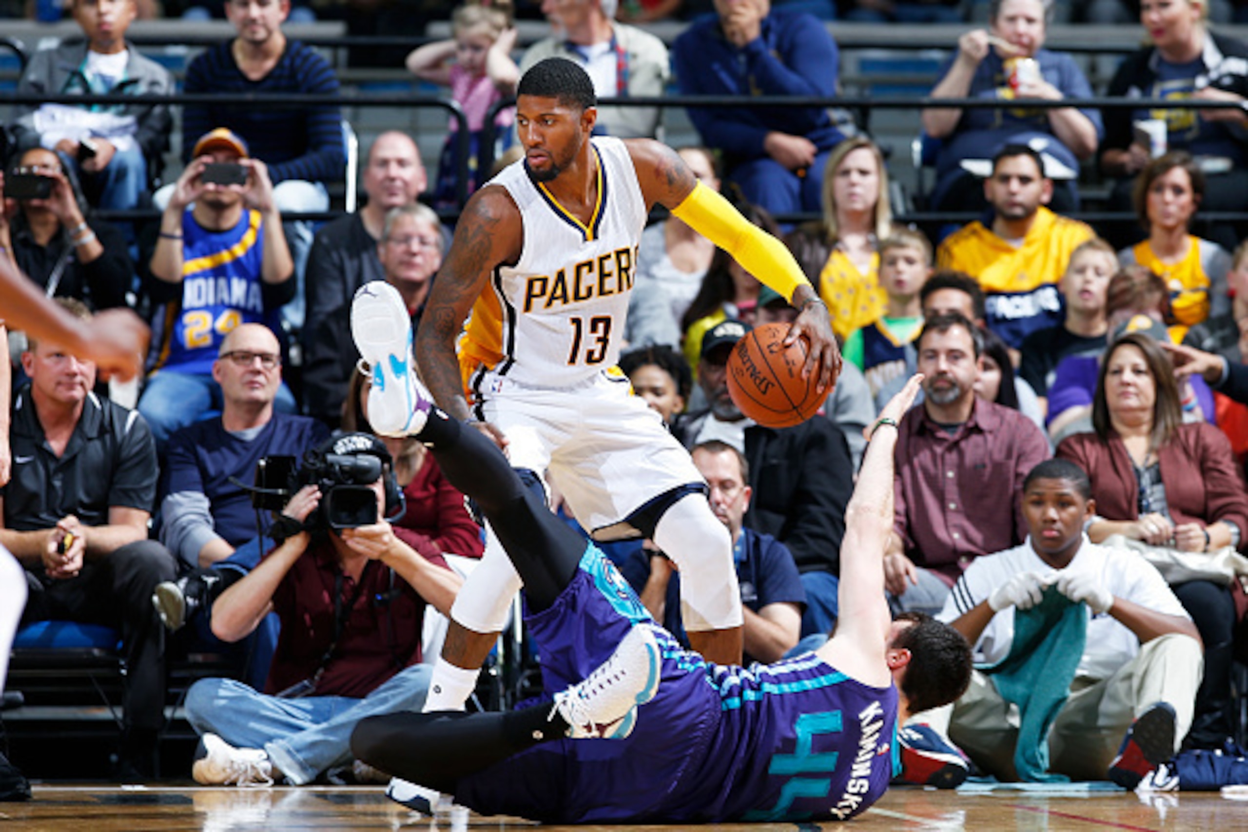FORT WAYNE, IN - OCTOBER 22: Paul George #13 of the Indiana Pacers gathers a loose ball away from Frank Kaminsky III #44 of the Charlotte Hornets during a preseason game at Allen County War Memorial Coliseum on October 22, 2015 in Fort Wayne, Indiana. The