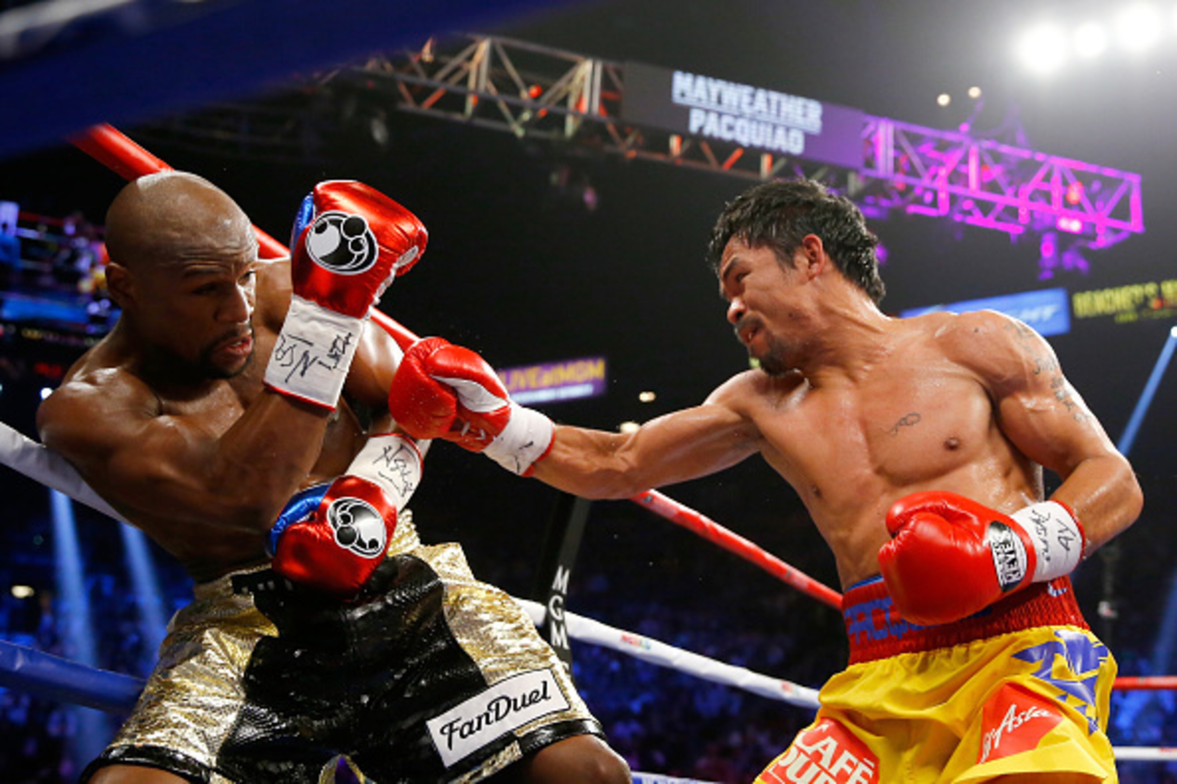 LAS VEGAS, NV - MAY 02: Manny Pacquiao throws a right at Floyd Mayweather Jr. during their welterweight unification championship bout on May 2, 2015 at MGM Grand Garden Arena in Las Vegas, Nevada. (Photo by Al Bello/Getty Images) LAS VEGAS, NV - MAY 02: Manny Pacquiao throws a right at Floyd Mayweather Jr. during their welterweight unification championship bout on May 2, 2015 at MGM Grand Garden Arena in Las Vegas, Nevada. (Photo by Al Bello/Getty Images)