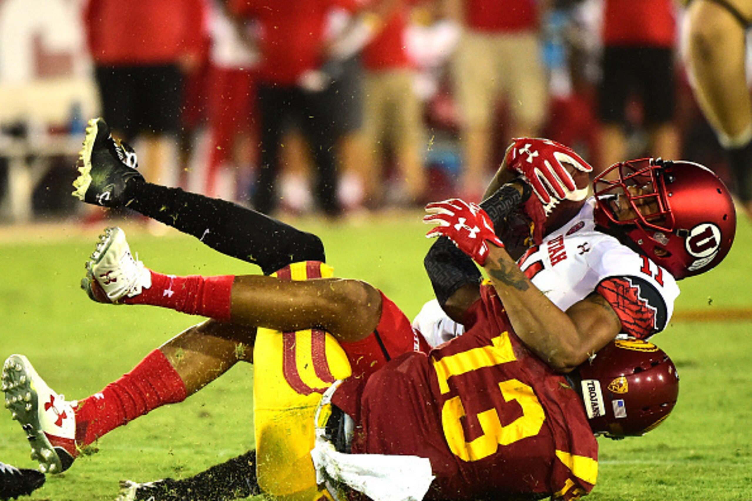 LOS ANGELES, CA - OCTOBER 24:  Raelon Singleton #11 of the Utah Utes is tackled by Kevon Seymour #13 of the USC Trojans during a 42-24 USC Trojans win at Los Angeles Memorial Coliseum on October 24, 2015 in Los Angeles, California.  (Photo by Harry How/Ge