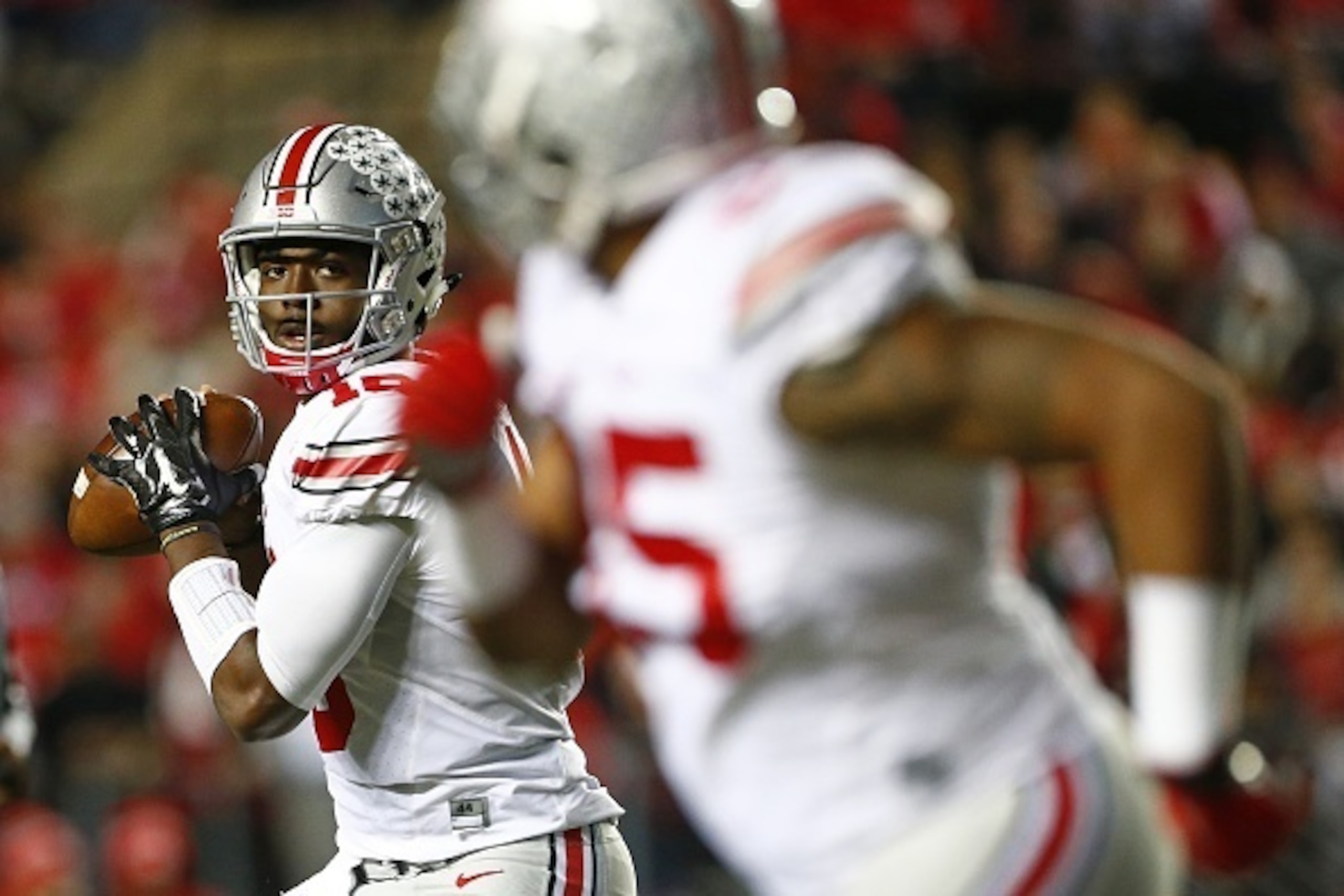 PISCATAWAY, NJ - OCTOBER 24: Quarterback J.T. Barrett #16 of the Ohio State Buckeyes looks to pass to Marcus Baugh #85 during the second quarter against the Rutgers Scarlet Knights at High Point Solutions Stadium on October 24, 2015 in Piscataway, New Jer