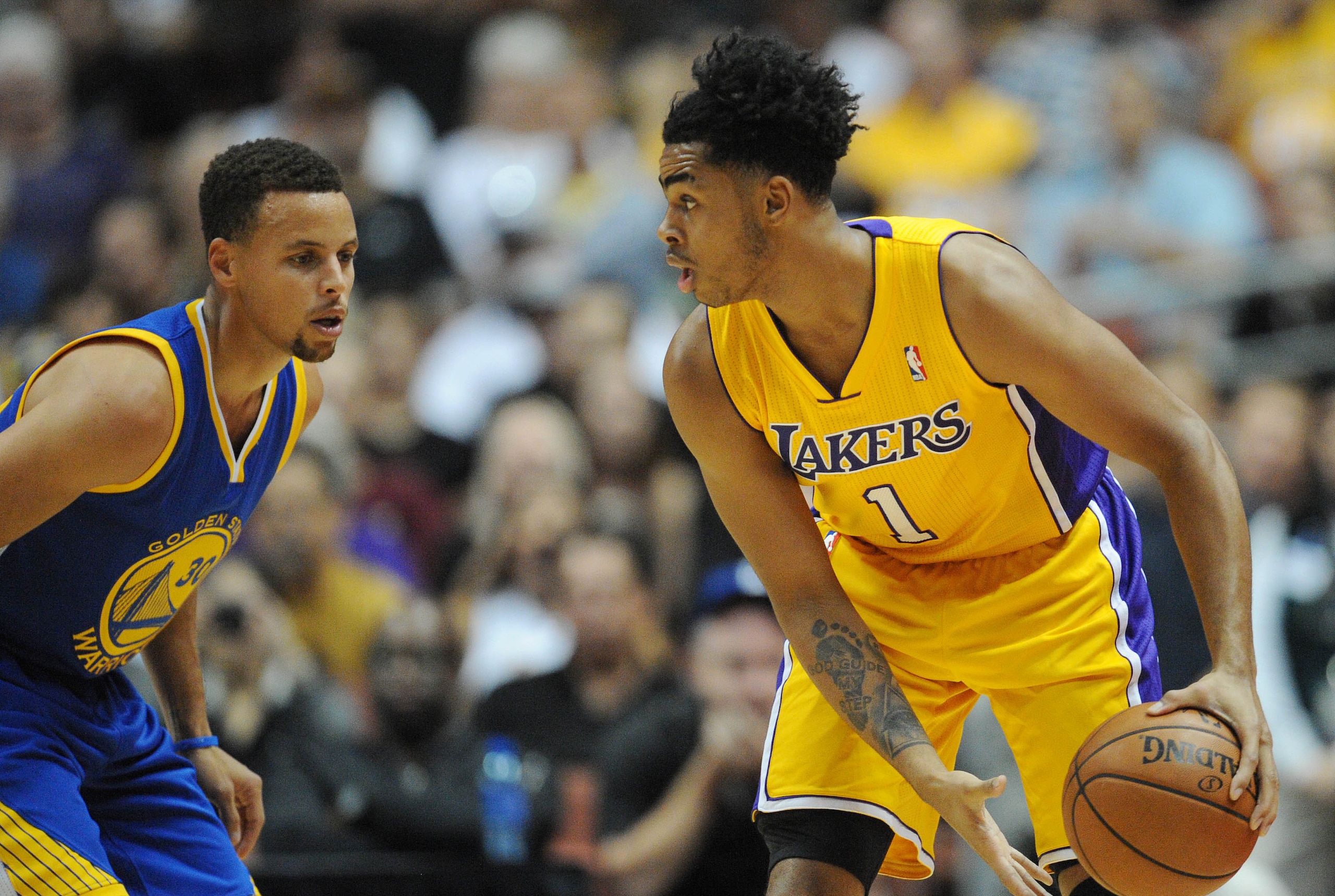 October 22, 2015; Anaheim, CA, USA; Los Angeles Lakers guard D'Angelo Russell (1) moves the ball against the defense of Golden State Warriors guard Stephen Curry (30) during the first half at Honda Center. Mandatory Credit: Gary A. Vasquez-USA TODAY Sport October 22, 2015; Anaheim, CA, USA; Los Angeles Lakers guard D'Angelo Russell (1) moves the ball against the defense of Golden State Warriors guard Stephen Curry (30) during the first half at Honda Center. Mandatory Credit: Gary A. Vasquez-USA TODAY Sport
