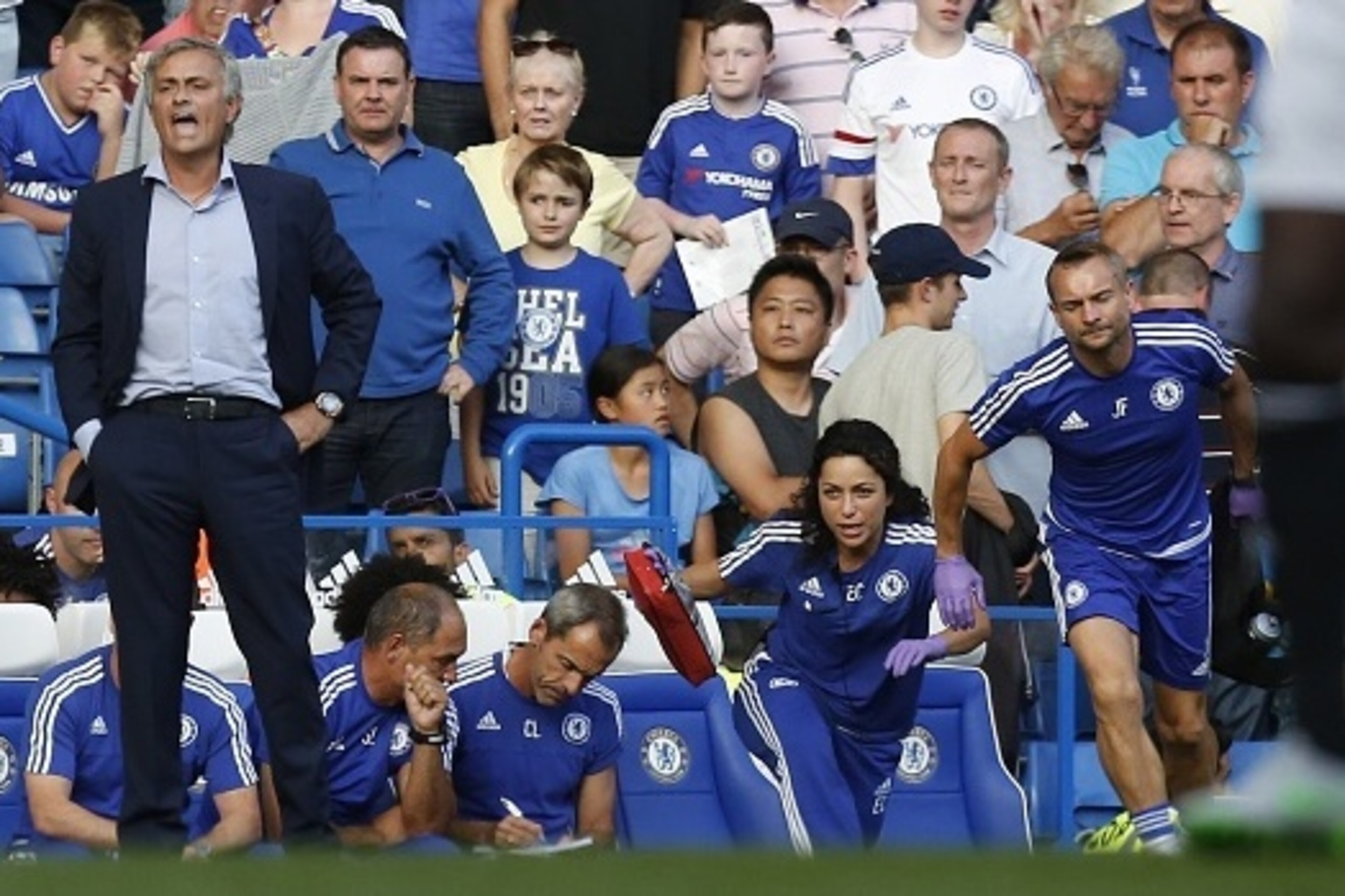 Chelsea doctor (2R) Eva Carneiro and head physio Jon Fearn (R) leave the bench to treat Chelsea's Belgian midfielder Eden Hazard late in the game as Chelsea's Portuguese manager Jose Mourinho (L) gestures during the English Premier League football match b