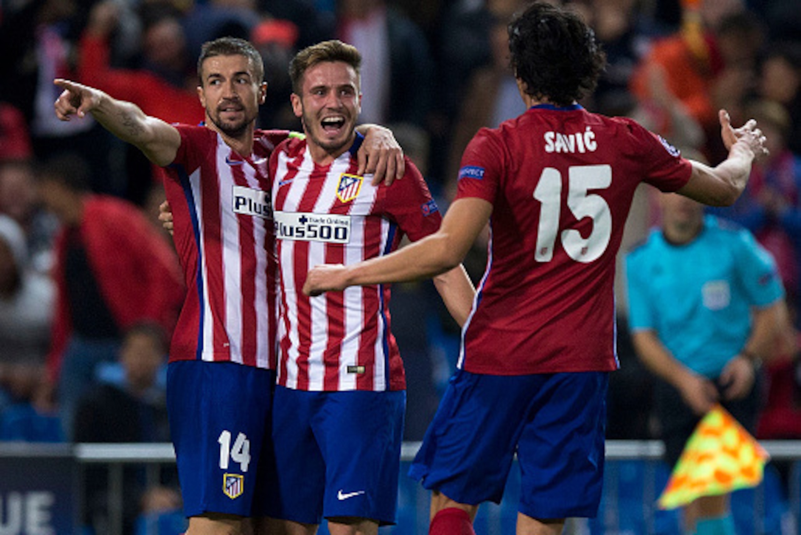MADRID, SPAIN - OCTOBER 21:  Saul Niguez (2ndR) celebrates scoring their opening goal with teammates Gabi Fernandez (L) and Stefan Savic (R) during the UEFA Champions League Group C match between Club Atletico de Madrid and FC Astana at Vicente Calderon s
