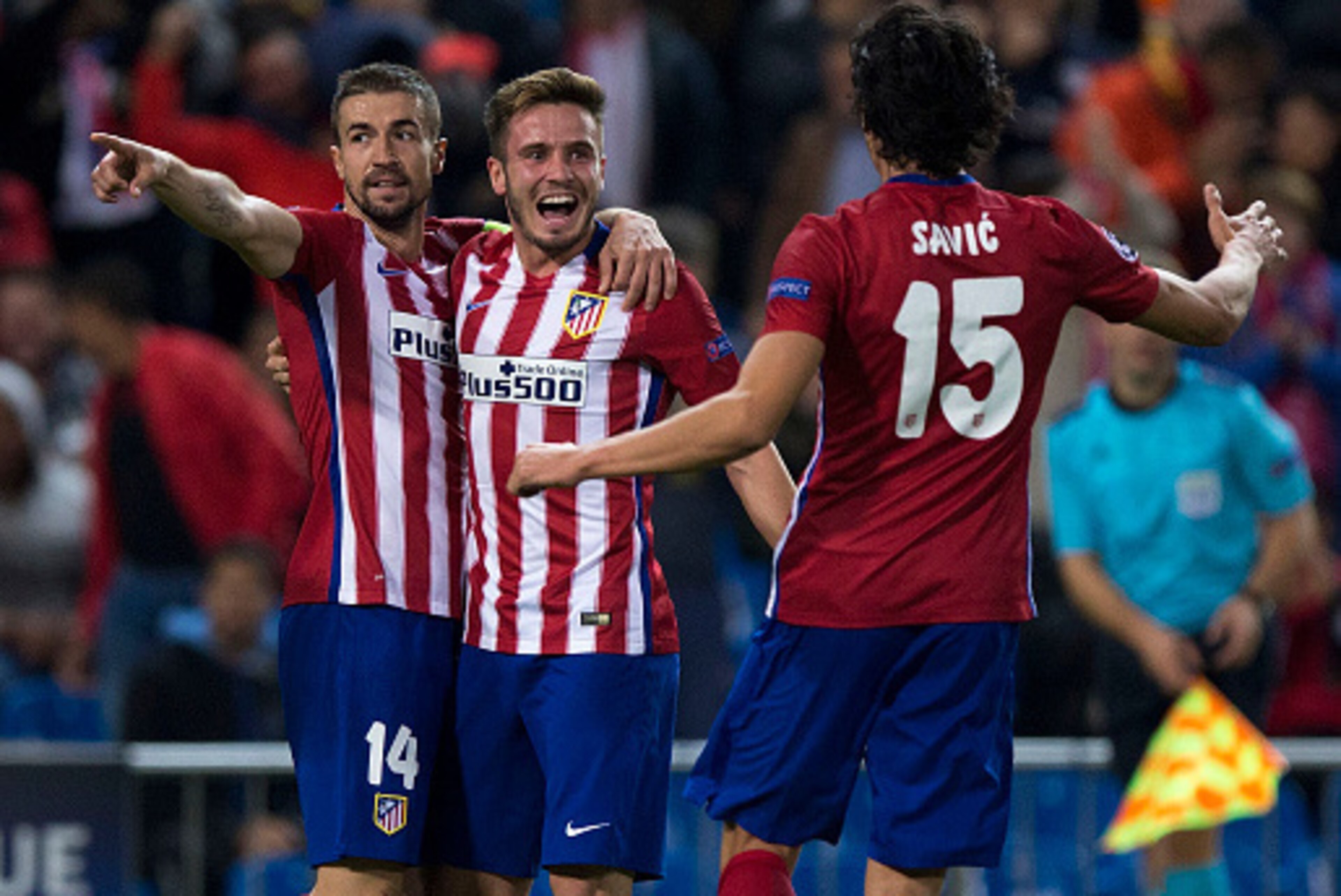 MADRID, SPAIN - OCTOBER 21:  Saul Niguez (2ndR) celebrates scoring their opening goal with teammates Gabi Fernandez (L) and Stefan Savic (R) during the UEFA Champions League Group C match between Club Atletico de Madrid and FC Astana at Vicente Calderon s
