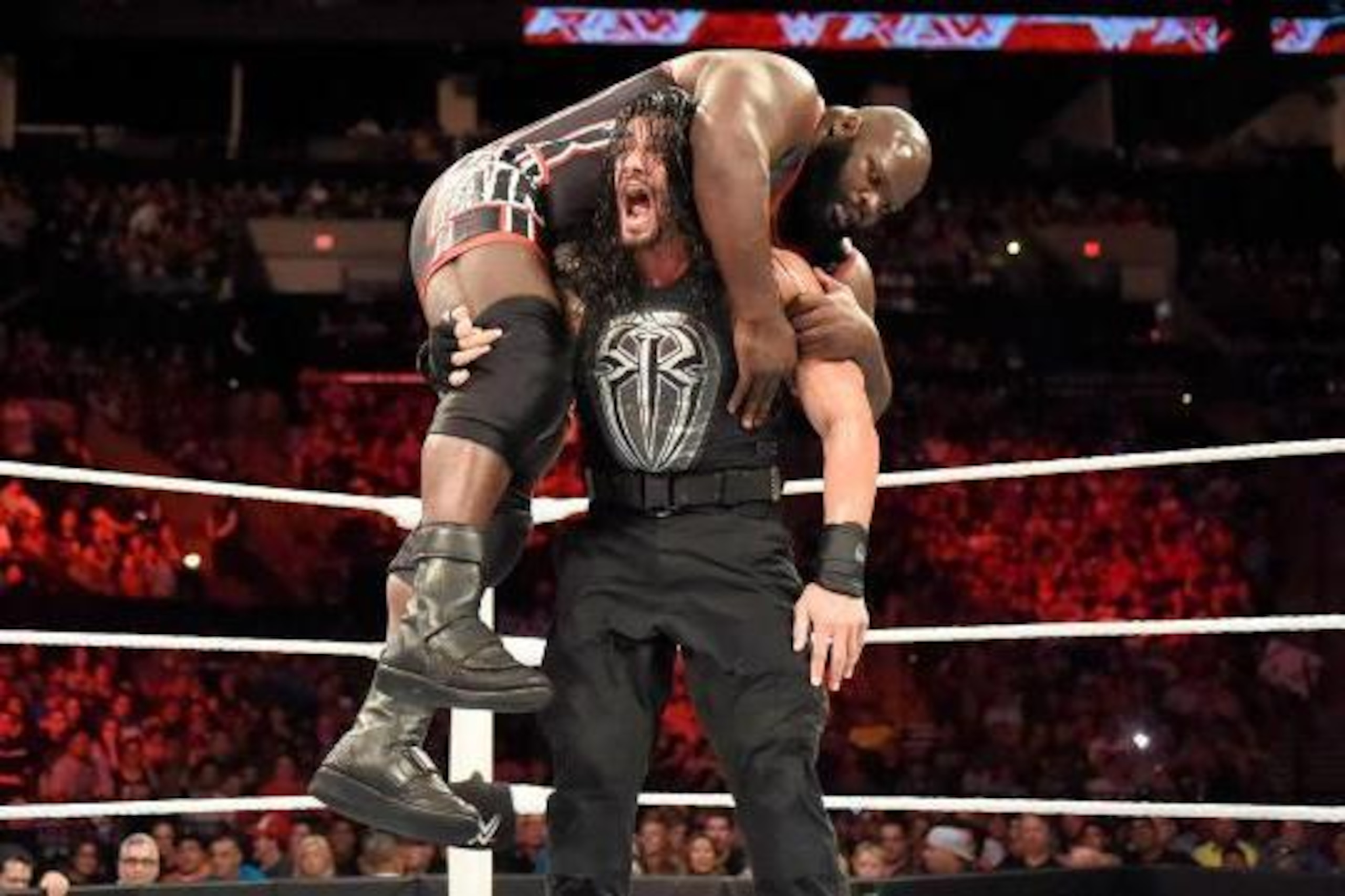 Roman Reigns battles Mark Henry.