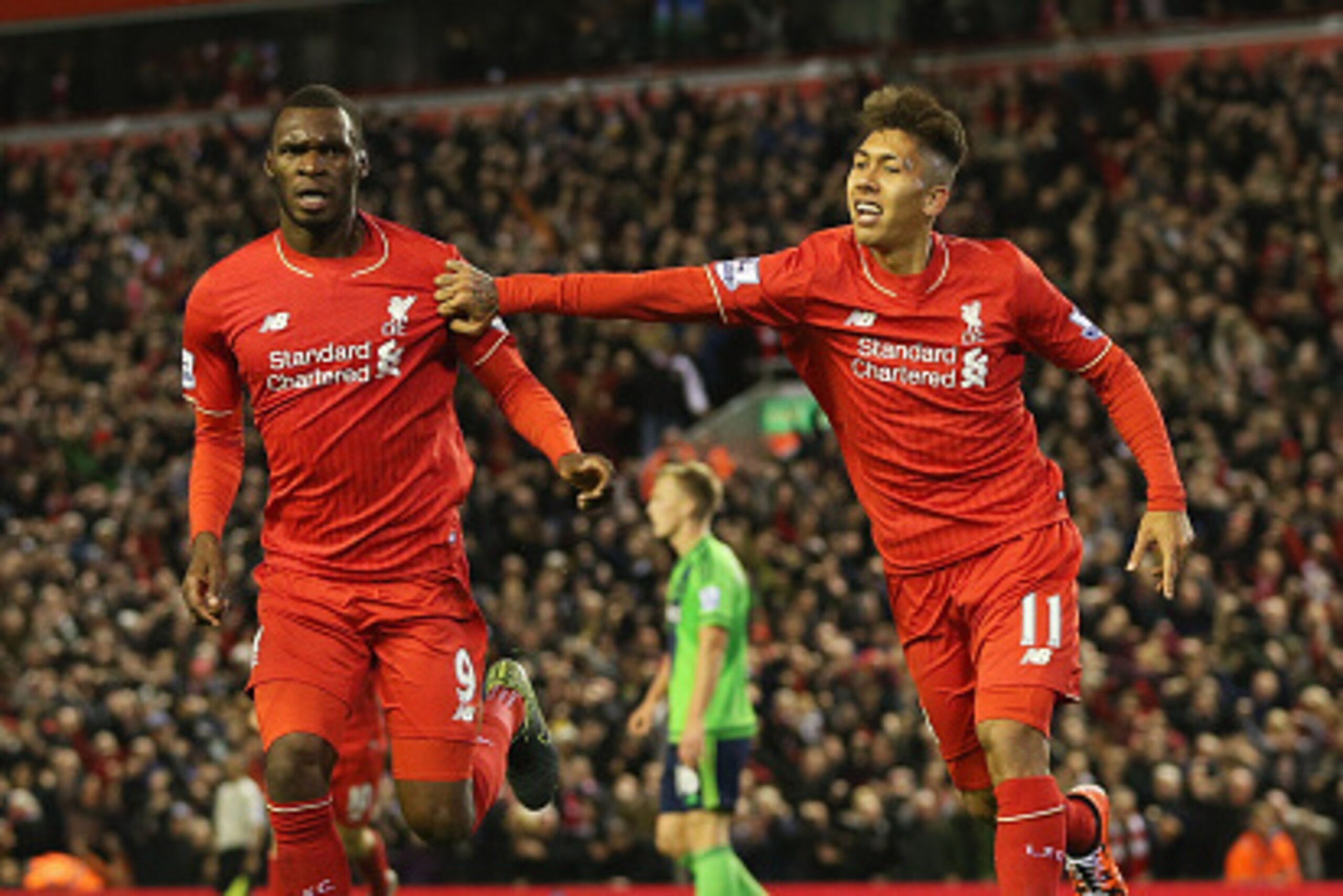 LIVERPOOL, ENGLAND - OCTOBER 25:  Christian Benteke (L) of Liverpool celebrates scoring his team's first goal with his team mate Roberto Firmino (R) during the Barclays Premier League match between Liverpool and Southampton at Anfield on October 25, 2015 