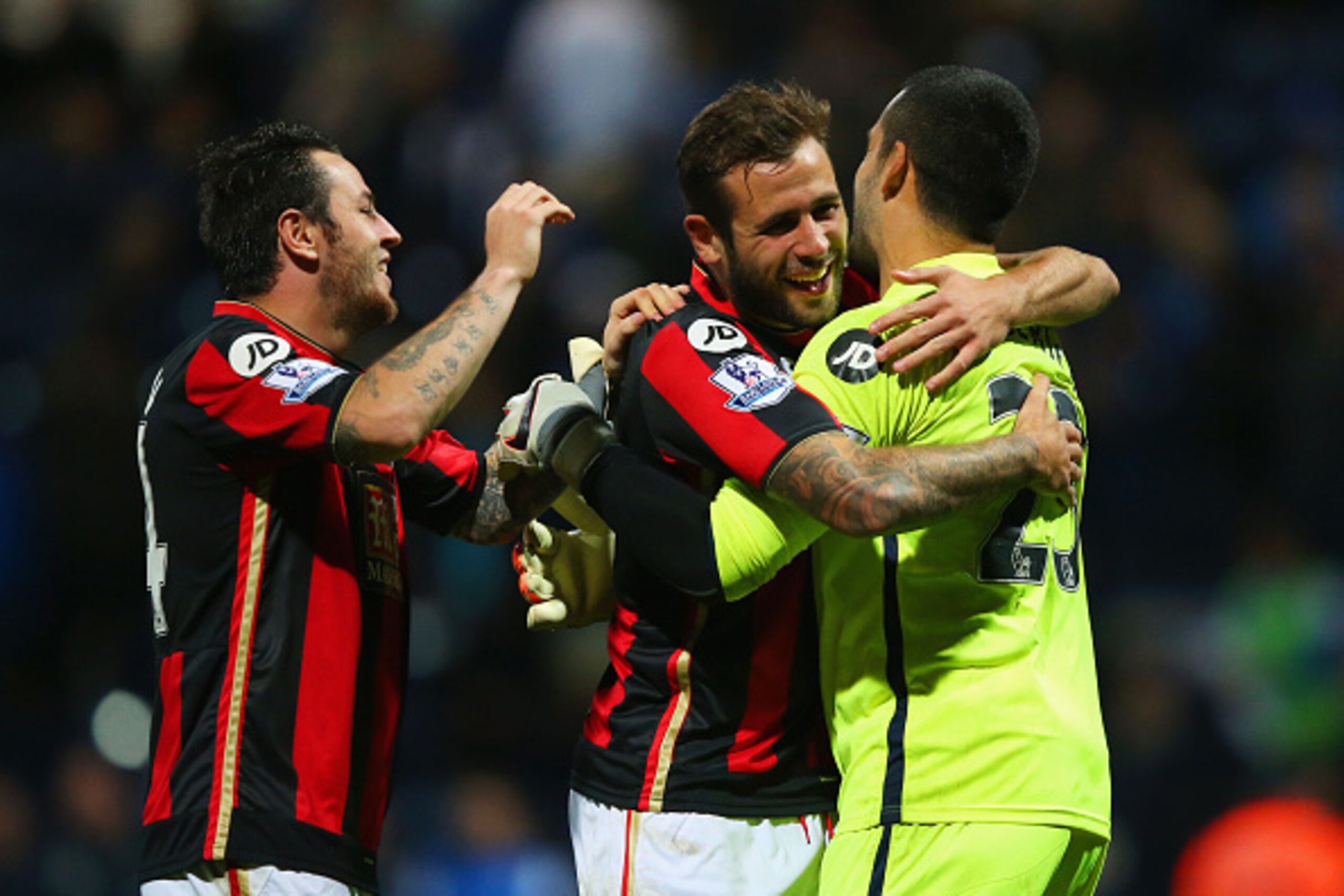 PRESTON, ENGLAND - SEPTEMBER 22:  Goalkeeper Adam Federici of Bournemouth (R) celebrates with team mates Lee Tomlin (L) and Steve Cook (C) of Bournemouth as he saves the decisive kick in the penalty shoot out during the Capital One Cup third round match b