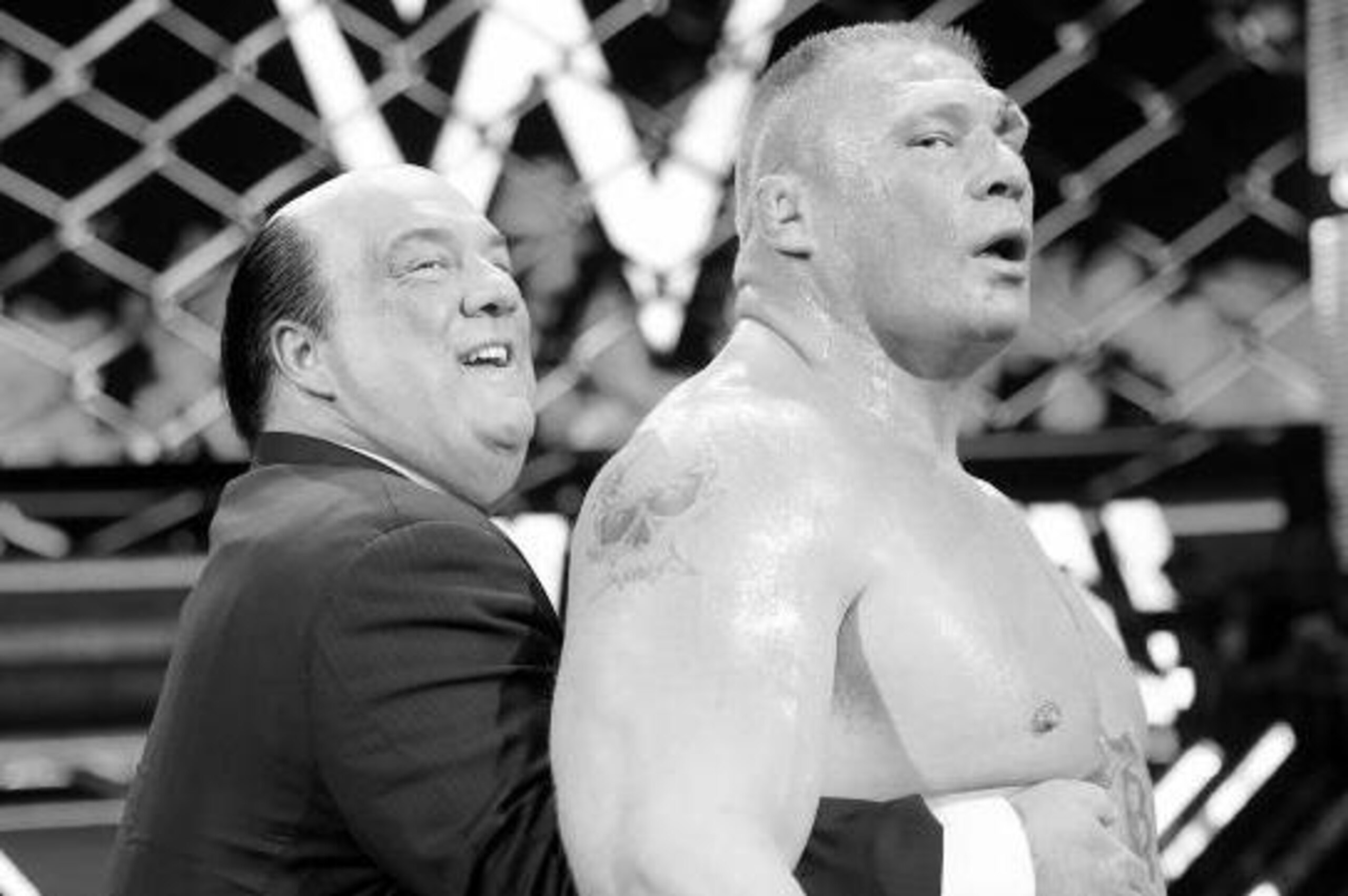 Paul Heyman congratulates his client Brock Lesnar after his Hell in a Cell win.