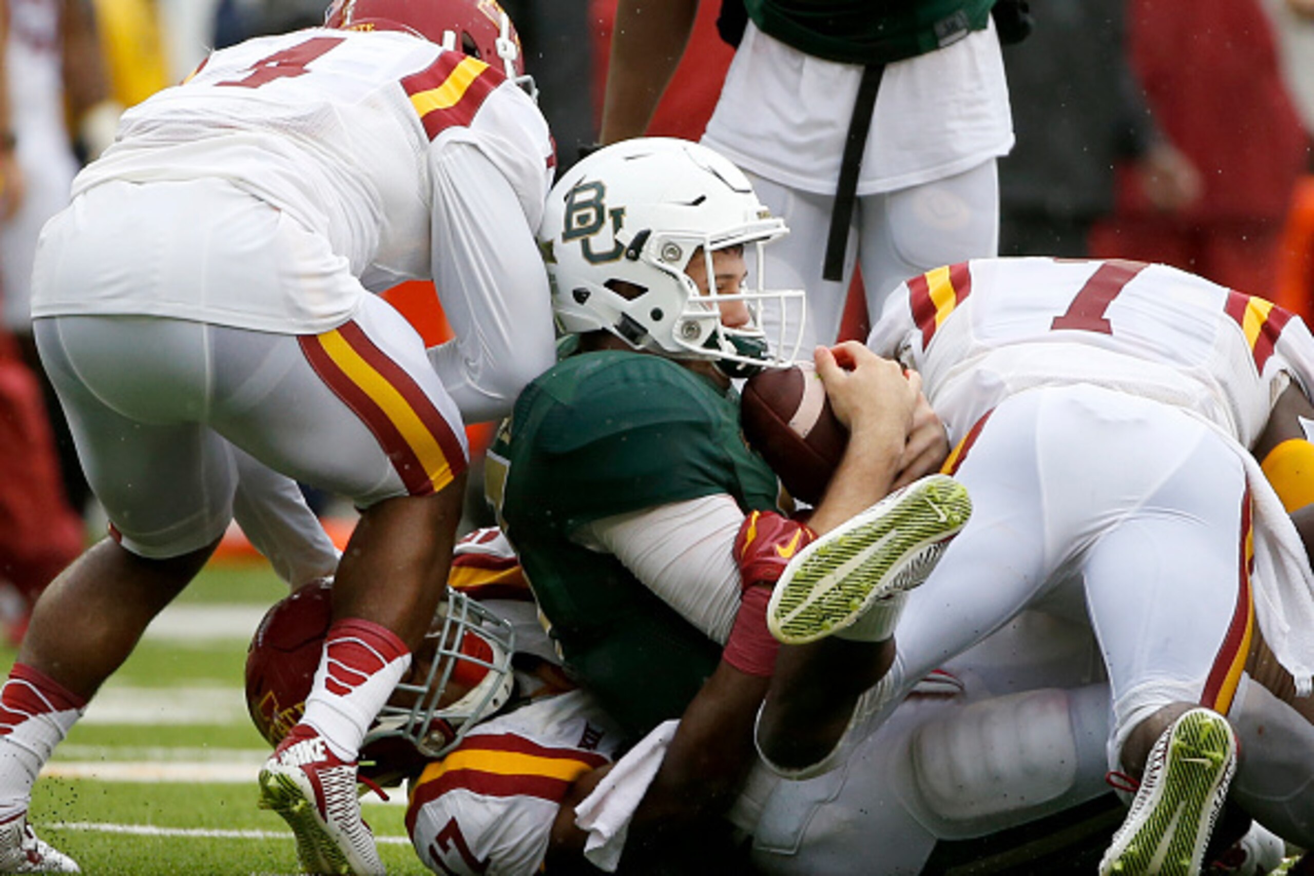 WACO, TX - OCTOBER 24: Seth Russell #17 of the Baylor Bears is stopped by Iowa State Cyclones defenders in the fourth quarter at McLane Stadium on October 24, 2015 in Waco, Texas. Baylor team officials said Russell, who left the field after the play, suff WACO, TX - OCTOBER 24: Seth Russell #17 of the Baylor Bears is stopped by Iowa State Cyclones defenders in the fourth quarter at McLane Stadium on October 24, 2015 in Waco, Texas. Baylor team officials said Russell, who left the field after the play, suff