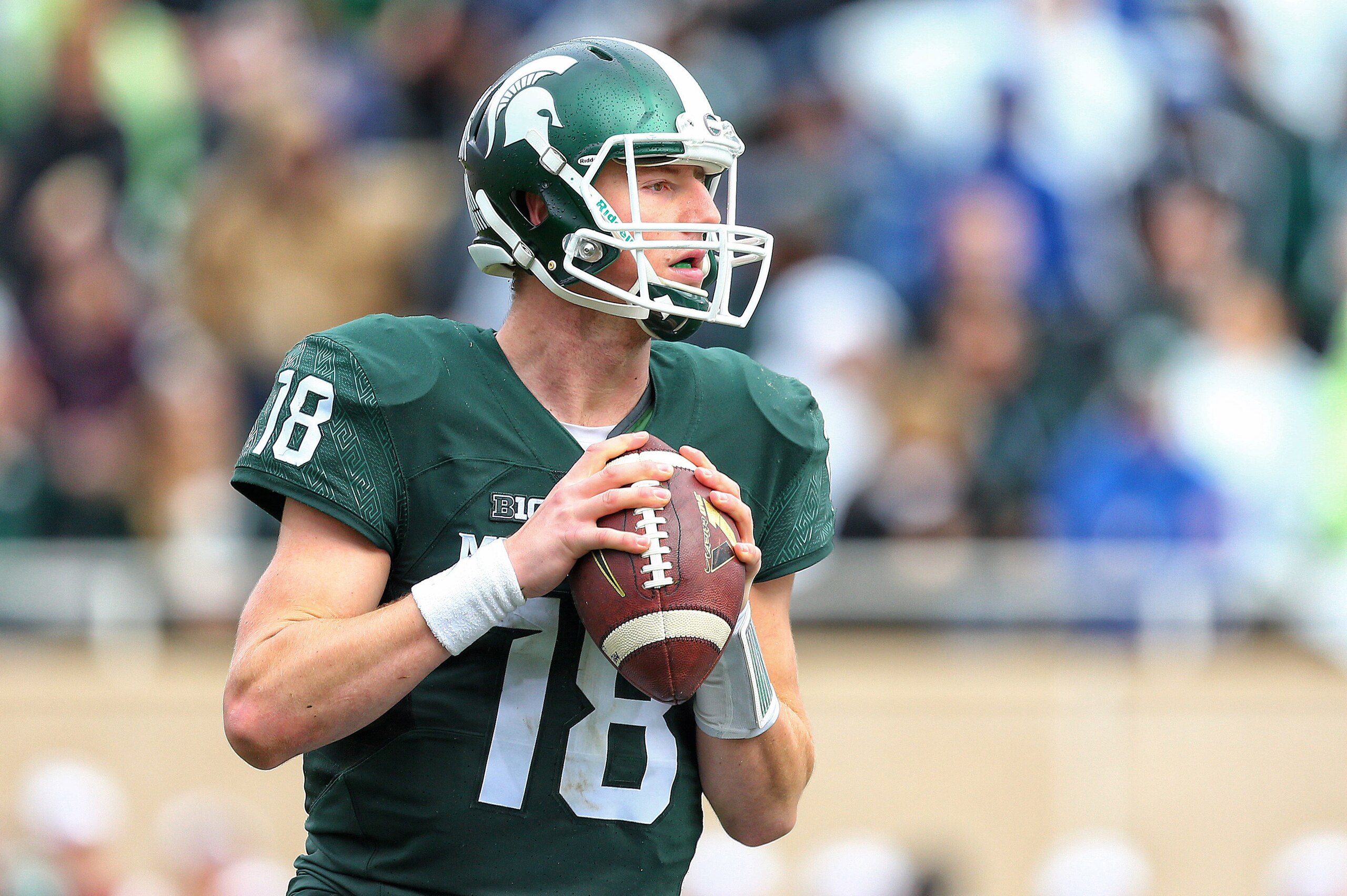 Oct 24, 2015; East Lansing, MI, USA; Michigan State Spartans quarterback Connor Cook (18) attempts to throw the ball against the Indiana Hoosiers during the 1st half of a game at Spartan Stadium. Mandatory Credit: Mike Carter-USA TODAY Sports