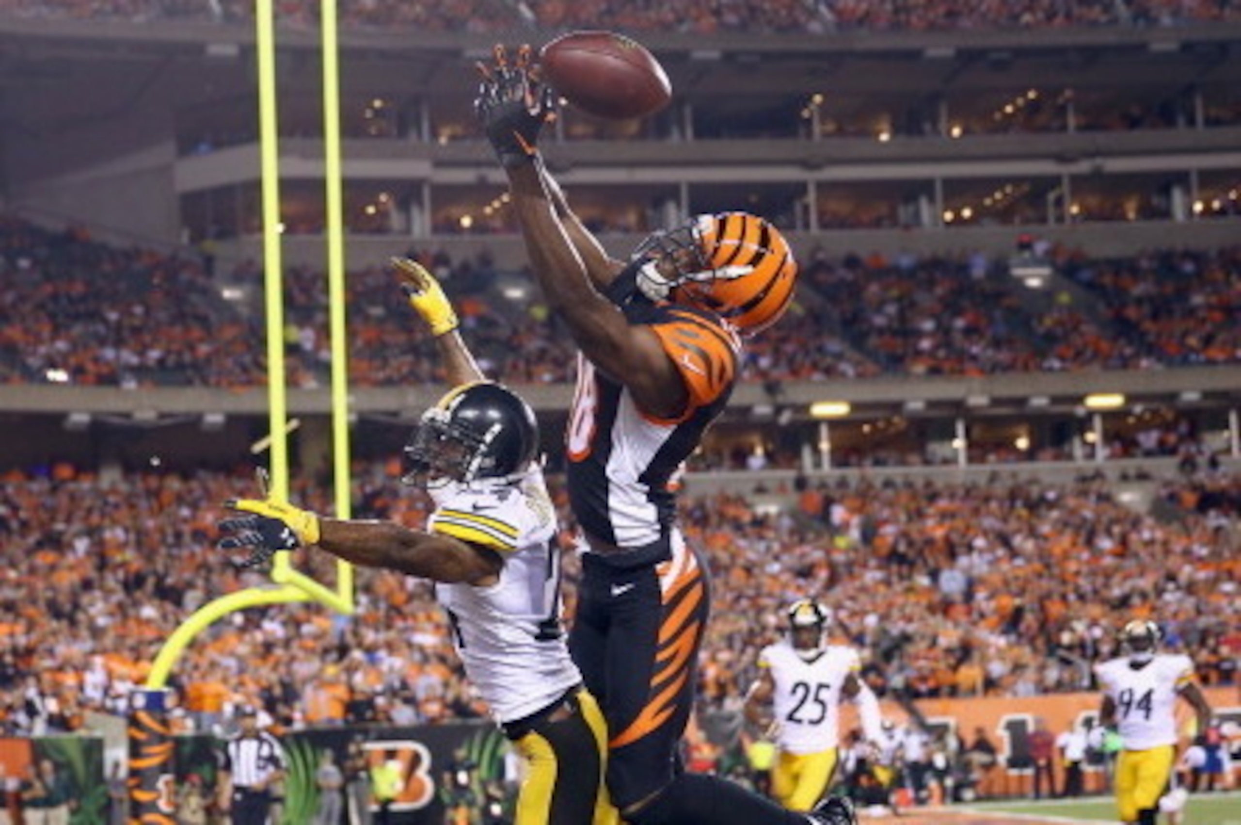 CINCINNATI, OH - SEPTEMBER 16:  A.J. Green #18 of the Cincinnati Bengals reaches for a pass that would fall incomplete while being defended by Ike Taylor #24 of the Pittsburgh Steelers during the NFL game at Paul Brown Stadium on September 16, 2013 in Cin